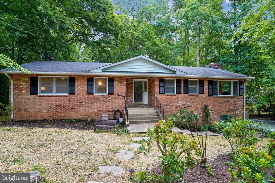This turn-key, single-family brick home with 5 bedrooms* and 3 full baths is situated on a 1-acre wooded lot in Manassas. Watch the birds from your deck and relax in the midst of nature!  *Although the house has 5 legal bedrooms THE SEPTIC SYSTEM PERCS FOR 3.  Over $50,000 in upgrades! Special features are: brand new 16 SEER high efficiency HVAC system with 10-year warranty; new front door; freshly painted shutters; freshly painted on both levels; gleaming, newly refinished hardwood floors; kitchen with breakfast bar opens to family room; kitchen with new quartz countertops, sink, faucet, flooring and recessed lights; new stainless refrigerator and new 5-burner, propane, Italian-made Empava stove; cathedral ceiling in the large family room; stone-faced, wood-burning fireplace in family room and a wood-burning stove in the lower level rec room; new recessed, dimmable lighting in living room and kitchen; formal dining room with chair rail; owner's suite located on the main floor; all three bathrooms have been refurbished and have new, high-efficiency, dual-flush toilets; 4 new ceiling fans; new brushed nickel hardware on kitchen cabinets and doors throughout the house; new light switches throughout the house; new wood steps to lower level; fully finished walk-out lower level; new flooring throughout lower level; ample storage with multiple large closets; pantry off of kitchen; newly-painted large deck overlooking large backyard; the fully-fenced backyard is great for pets with lots of room to run; stairs from deck to patio; one-car garage with workbench and shelves; and storage shed.  This section of Kahns Road has no through-traffic.  Septic and fuel tank inspections passed with flying colors.