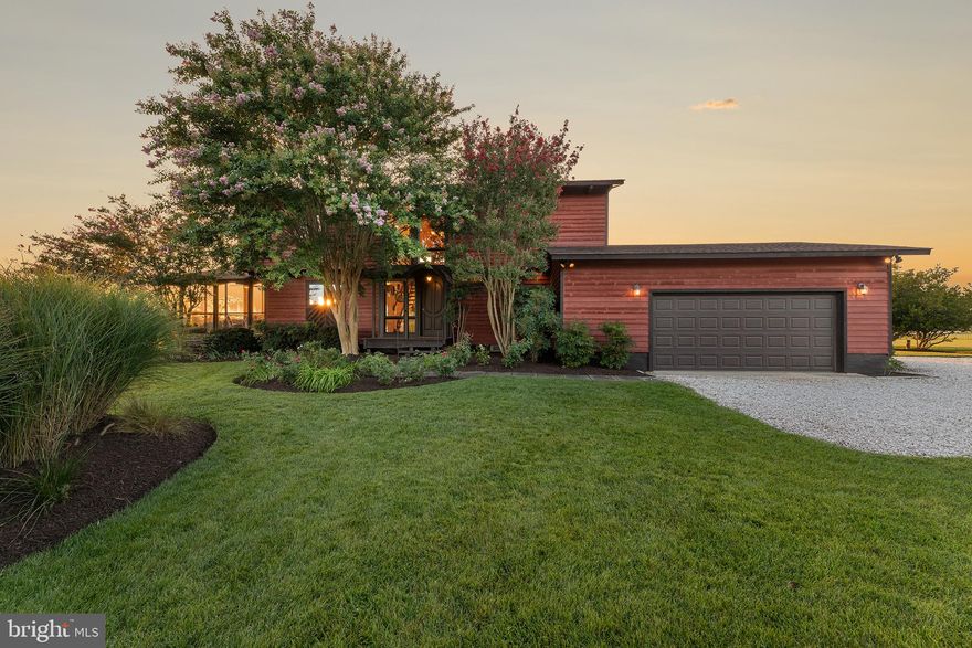 Welcome to your Great Escape! Nestled amidst the serene beauty of 9 waterfront acres with over 220 feet of protected shoreline, this stunning waterfront home boasts a truly picturesque setting that is an ideal secondary residence or primary home. As you approach the property, a private driveway meanders through the acreage of the waterfront setting, creating a sense of anticipation for the breathtaking reveal that awaits. This meticulously maintained 4 bedroom, 3 full bath home with elevator and attached 2 car garage parking home offers panoramic views of Madison Bay and is a sanctuary for those seeking respite from the world. Upon entering the home, you are greeted by an open main level with inviting foyer, beautiful hardwoods, vaulted ceilings and exposed beams. The open-concept living area offers spacious vistas of the waterfront through expansive floor-to-ceiling windows with automatic shades that provide uninterrupted views of the waterfront, setting a serene mood for private thoughts or social gatherings. The well-maintained kitchen opens to the dining area bathed in soft natural light that is just perfect for hosting family and friends. The adjacent screen porch is the perfect environment for regular meals as well as easy outdoor entertaining where you can enjoy ever changing sunsets, and wildlife including swans, ducks, seagulls, osprey, and eagles that drift by. The living room opens to the newly expanded back deck that offers a front-row seat to the awe-inspiring beauty of the water and sunsets. Whether you're sipping your morning coffee or toasting to another day's end, this deck transforms each moment into a special memory. The main level bedroom features private deck access overlooking the waterfront, allowing you to wake up to a sunrise that colors the water or to unwind with a glass of wine as the sun sets. All bedrooms are thoughtfully designed, each offering unique views of the waterfront and ample space for guests or family members. A fourth bedroom that can be used as an office or study provides a peaceful work environment with inspiring views of the surrounding natural beauty. The private elevator offers seamless access to all levels with just the push of a button and simplifies daily life in the most luxurious manner. This turnkey home includes newer Bosch split high efficiency Heat Pump units with Aquecoil oil backup heat, PVE Pneumatic 2 stop elevator elevator in 2021, upgraded bathroom tiles, expanded deck, new Anderson windows and doors throughout, and motorized living room shades. A two-car garage and an expansive parking pad offer a combination of covered and overflow parking making this home just perfect for multiple vehicles. Outside, the property truly shines. The spacious deck with comfortable seating areas provides the perfect spot for al fresco dining or simply soaking up the sun while taking in the mesmerizing sights and sounds of the water and wildlife. This meticulously landscaped property includes newly planted sapling trees and level grassy yard that leads to the water's edge, where you'll find high-end rip rap with boulder style stones carefully chosen to blend harmoniously with the natural surroundings and provide protection while creating an attractive and visually pleasing shoreline. This home's stunning waterfront setting is not just a backdrop but an integral part of its charm and appeal. It offers an oasis of peace and tranquility, where you can escape the hustle and bustle of everyday life and immerse yourself in the beauty of nature. This is a place where memories are made, amazing sunsets can be enjoyed and moments become treasured experiences, making it the perfect haven for those seeking a truly exceptional waterfront lifestyle. This home is a short drive to Cambridge with shopping, dining, entertaining, the arts, marinas, boating and fishing. Come home to your Great Escape!