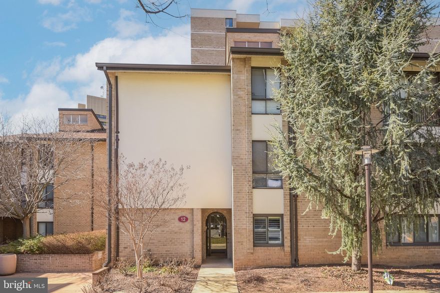 PRICE CORRECTION! Welcome to your prospective residence. This meticulously renovated 2-bedroom, 2-bathroom garden condominium presents a unique opportunity to experience modern living in a comfortable setting. The living room is designed to maximize natural light, featuring floor-to-ceiling windows that provide access to a welcoming patio. The presence of built-in remote-controlled shades ensures both convenience and aesthetic appeal. The kitchen is equipped with premium quartz countertops, a designer backsplash, and a suite of stainless steel appliances, including a dishwasher, stove, refrigerator, microwave, and wine refrigerator. Additionally, the unit includes a conveniently located stacked washer and dryer.
The condominium is adorned with elegant crown moldings and recessed lighting throughout, contributing to a warm ambiance. The primary suite serves as a private retreat, complete with an en-suite bathroom featuring a spacious walk-in shower and a Wi-Fi-enabled mirror. The primary suite also includes tasteful window treatments, while the secondary bedroom is fitted with plantation shutters. The hallway bathroom offers a bathtub, providing versatility for both bathing and showering. With upgraded modern flooring throughout the unit, maintenance is straightforward, allowing for a more enjoyable living experience. The private patio provides an ideal space for enjoying morning coffee or relaxing in the evening. The community amenities are noteworthy, featuring an outdoor pool, sauna, exercise room, and meticulously maintained common areas that cultivate a sense of community. For added convenience, the property includes an assigned parking space in the basement garage and a dedicated storage cage for personal belongings. Its location provides easy access to Rockville Town Center, Metro, public transportation, dining, shopping, and essential services, making daily commutes efficient. The condo fee encompasses all utilities, the maintenance of common areas, as well as concierge services that provide enhanced peace of mind. This building also distinguishes itself as one of the most pet-friendly options in the vicinity. This property represents not merely a residence but a comprehensive lifestyle choice. We encourage you to consider this remarkable opportunity to make it your own.

*Beginning in 2016 through 2022, Americana Centre underwent significant infrastructure repairs and cosmetic upgrades to bring the buildings up to current standards and ensure the health and efficiency of the central plant. The work included extensive waterproofing of the high-rise buildings, balcony refurbishment, replacement of the central plant (boilers and chillers), replacement of high-rise sanitary stack pipes (kitchen drain pipes), replacement of high-rise and garden risers (pipes that deliver water for air conditioning and heating), and repairs to the underground parking garage. In addition, lobbies and hallways were revamped with new design elements, including paint, carpet, lighting, unit door knockers, and signage.*