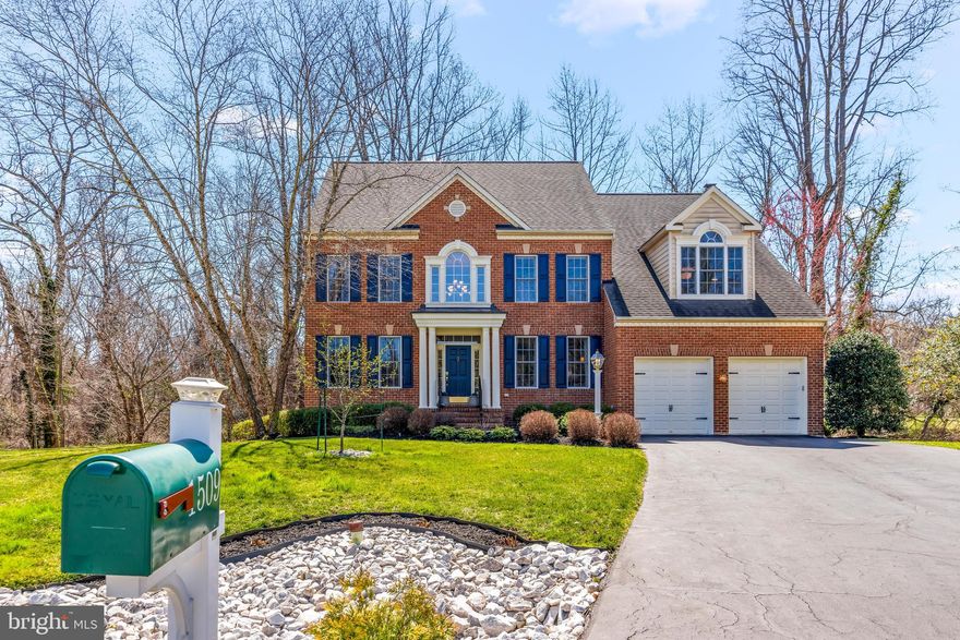 Absolutely beautiful colonial style home on the Broadneck peninsula! Located in quiet neighborhood Colonial Manor, this home is located in a small, private cul da sac backing up to woods to provide the perfect privacy especially in spring/summer with full bloom. Offering over 4,000 finished square feet inside, come fall in love with this floor plan. This home boast tall ceilings throughout making the whole house feel airy and bright. As you enter into the 2 level foyer, the space separates into an office or library with gorgeous built in shelving and the dining room on the other side flowing into the open concept kitchen and living room in the rear of the home. The living room is flooded with natural light and a huge space centered by milk-painted fireplace and custom built in shelving. The gourmet kitchen has an oversized island, top of the line appliances, and beautiful cabinetry. Behind kitchen is a main level bedroom with full bathroom - this space could also be used as an office, playroom, or however you imagine it! The upstairs offers 4 bedrooms - with the primary bedroom being an a show stopper. Not only is the room massive, the bonus room off the side offers additional living space, additional storage closet, and a laundry room. Yes you read that right, a laundry ROOM off the primary bedroom upstairs. The primary bedroom also has a remodeled full bathrooms w/ stand up shower and separate soaking tub, double sink oversized vanity and toilet closet. There are 3 more additional secondary great sized bedrooms sharing a hallway full bathroom. The basement offer even more finished space and remodeled, enlarged bathroom. The basement space could be perfect for Au Pair or In-Law Suite w/ walk out level to exterior. There is an additional unfinished storage room and exercise room. Seller will be leaving some gym equipment. Did I even mention there is an attached 2 car garage and driveway enough for multiple cars? The exterior is complete with a A+ oversized deck overlooking the private lot and paver patio off the side of the deck. Recent seller improvements include completely renovated primary bathroom, main level bathroom, and basement bathroom, replaced primary bedroom and primary bedroom sitting area with hardwood flooring, replaced flooring in the basement to LVP, and much more. Be sure to check list of all seller improvements in document section. Districted to top rated Broadneck School District. Property has a VA assumable loan of 2.5% interest rate - talk to listing agent for more details!