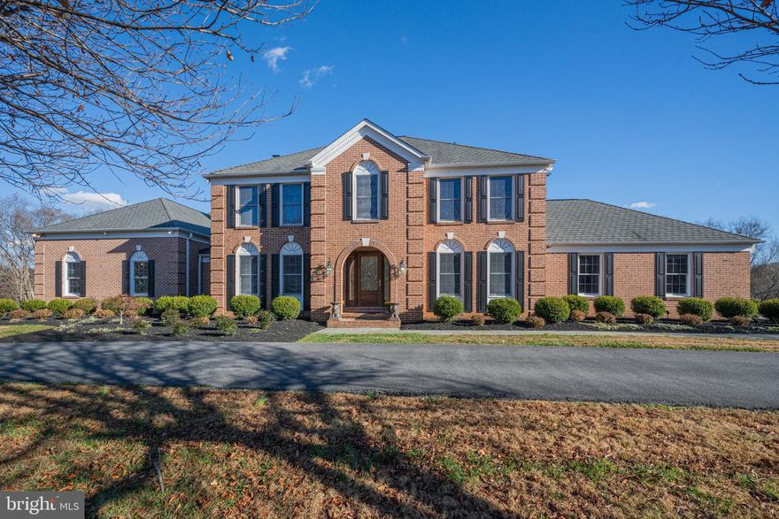 Stunning Custom Estate in Sought-After Brighton Pines
Perfectly sited on a beautifully manicured 3.48-acre lot along a peaceful street in the desirable Brighton Pines community—within the coveted River Hill High School District—this stately all-brick custom home offers over 6,200 finished sq. ft. of exceptional living space. A substantial structural renovation in 2010 transformed the home, adding a spectacular sun-drenched chef’s kitchen with 11-ft ceilings, custom cabinetry, granite countertops, and Energy Star appliances, including a commercial Wolf double oven with grill and griddle, stacked stone backsplash with pot filler, custom copper range hood and farmhouse sink, two dishwashers, two refrigerators plus freezer drawers, warming drawer, and dual islands—perfect for entertaining. The adjoining octagonal breakfast nook with recessed dome ceiling and five Palladian-topped windows overlooks the expansive rear yard and maintenance-free Azek deck. The 2010 addition also expanded the home to include an oversized 43’x27’ three-car garage with motion-sensor LED lighting, a fourth tractor shed garage, and a main-level in-law/au pair suite with a private entrance, full bath, and large laundry room—ideal for multi-generational living. Inside, a dramatic 39’x16’ great room features a floor-to-ceiling stacked-stone fireplace with wood stove insert and multiple French doors leading to the deck. Elegant arched entryways, crown and chair rail moldings, and hardwood floors highlight the formal dining room and private office. The finished lower level (2019) offers abundant space for a media room, wine cellar, workshop, guest suite, or gym, complete with a full bath. Upstairs, the luxurious owner’s suite includes dual vanities and a walk-in closet, along with two secondary bedrooms and an office. Additional upgrades include Andersen 400-series windows, a constant-pressure water system with softener and filter, security system with multiple video cameras, driveway vehicle alert system, high-efficiency geothermal units, and a 10kW owned solar system—resulting in remarkably low utility costs (average $200/month). Enjoy a flat, cleared rear yard—ideal for a future pool, sports court, or simply peaceful outdoor living. Convenient to major routes (I-95, I-695, MD-32, Route 29), Columbia Town Center, Brighton Dam Azalea Park, and Patapsco River recreation. This meticulously maintained estate combines timeless elegance, thoughtful design, and sustainable luxury—an extraordinary opportunity in one of Howard County’s premier neighborhoods.