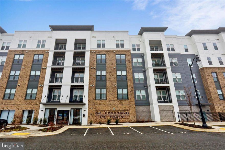 Welcome to penthouse living at Element at Mill Creek, one of Annapolis’ most stylish and thoughtfully designed 55+ communities. This 2 bed + Den, 2 bath top-floor residence with in-home laundry offers the privacy and quiet you’ll appreciate, paired with the elevated finishes and upgrades that truly make it better than new construction. From the moment you enter, you’ll notice the difference. Since purchasing, the owner has enhanced the home with carefully selected upgrades—refined lighting, custom touches, and elevated finishes that go beyond the builder’s base offerings. The result is a move-in-ready home with personality, warmth, and polish already in place. No waiting on construction timelines, no post-settlement projects—just effortless living from day one. This penthouse unit enjoys abundant natural light and peaceful views, along with the convenience of an assigned parking space in a secure garage—providing comfort and ease year-round. Life at Element at Mill Creek is designed for connection, wellness, and enjoyment. Residents enjoy a beautifully appointed clubhouse featuring indoor and outdoor dining spaces, a state-of-the-art fitness center, gathering rooms, and even a golf simulator for year-round play. Outdoors, you’ll find pickleball courts, scenic walking trails, and a dedicated dog park—perfect for staying active and social while enjoying the thoughtfully landscaped grounds. The community’s modern coastal architecture and easy layout create a fresh, welcoming neighborhood atmosphere that feels both intimate and sophisticated. Located just minutes from downtown Annapolis, you’ll have easy access to everything that makes the area so special—waterfront dining, boutique shopping, art galleries, live music, and year-round festivals. Spend afternoons strolling along City Dock, catching a sailboat race on the Chesapeake Bay, or enjoying dinner at one of the many acclaimed local restaurants. The charm, history, and vibrant lifestyle of Annapolis are right at your doorstep. And unlike many new construction purchases—where buyers are often responsible for the majority of closing costs—this resale offers a more traditional and balanced approach, with costs typically shared between buyer and seller. Title insurance discount also available. Stylish, upgraded, and ideally located, this penthouse at Element at Mill Creek offers the perfect blend of low-maintenance luxury, active living, and the best of Annapolis just moments away.