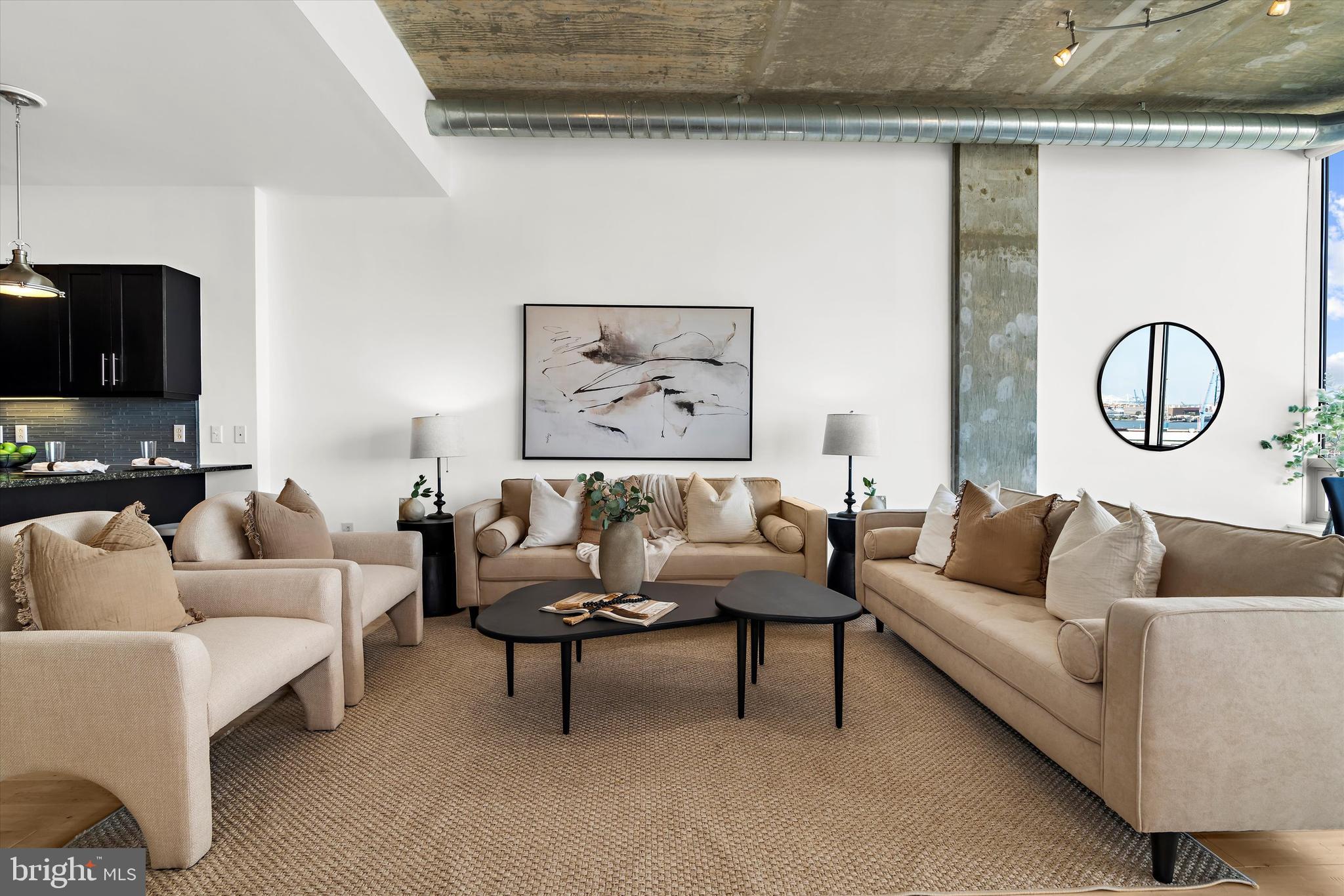 Welcome to Unit 913 at Silo Point, where luxury meets history in Baltimore’s iconic Locust Point neighborhood. This exquisite 2-bedroom, 2.5-bathroom condominium spans 1,866 square feet, offering a blend of industrial elegance and modern sophistication.
Upon entering, you’ll notice the impressive ceilings over 10 feet high and the open-concept layout that maximizes space and light. The expansive floor-to-ceiling windows, featuring motorized blinds and offering ninth-story vantage point views, extend from Fells Point to the former Key Bridge site and beyond, filling the home with natural light and highlighting the rich hardwood floors throughout. This home has been freshly painted, enhancing its pristine and inviting atmosphere. A new HVAC system was installed in July 2024, ensuring year-round comfort and energy efficiency.
The gourmet kitchen is a chef’s dream, equipped with high-quality Viking stainless steel appliances, elegant granite countertops, and a tasteful backsplash.
The primary suite is a retreat within the home, featuring a custom walk-in closet and a luxurious bathroom with a soaking tub and dual vanity. The second bedroom includes an en-suite bath, offering additional privacy. The powder room is designer-decorated, adding a touch of elegance, while custom lighting throughout the unit enhances its modern flair.
From your private balcony, enjoy panoramic water views, perfect for relaxation at any time of the day. The unit also includes in-unit laundry and two deeded garage parking spaces.
Residents of Silo Point have access to premium amenities, including a fully-equipped fitness center with a yoga studio, a game room, a pet area, and the 19th-floor Sky Lounge with impressive views of the harbor and city skyline. With a location near Fort McHenry and the Inner Harbor, this home offers luxury and convenience in one of Baltimore’s most distinguished buildings.