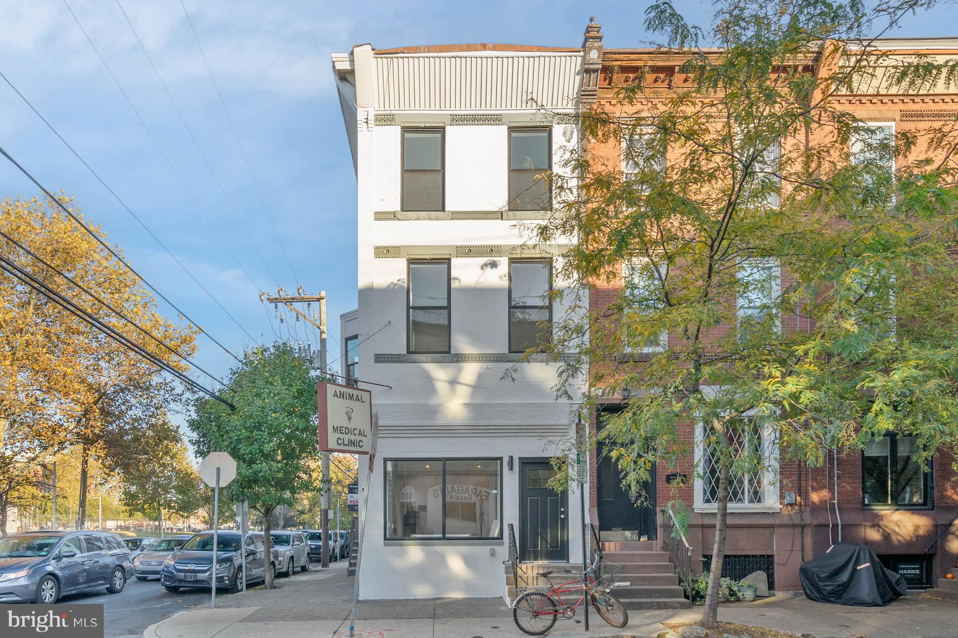 1401 S 13th is a premier mixed use building located in the heart of Passyunk Square overlooking Columbus Square Park. This gorgeous corner building was meticulously renovated with a LEGALLY ZONED parking space. The first floor is a wide open commercial space overlooking the park. Vanilla boxed and ready for the next tenant. The upstairs residential unit is a beautifully designed 3 bedroom, 2 bathroom, bi-level home. The first floor of the home features a large kitchen and living space, plenty of storage and a large bedroom and full bathroom. Up the stairs, a nice sized flex space with dry bar will open up into a nice size roof deck, perfect for cooking out or entertaining. The floor features two additional bedrooms, full bathroom and full sized laundry. This is a great building on a great block. The ceiling heights throughout are fantastic as well. Come tour and make this your next blue chip investment.