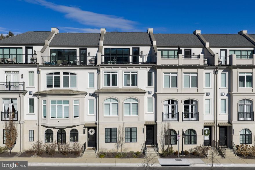 Bethesda’s premier gated townhome community. Quarry Springs offers privacy, security, and resort-level amenities just minutes from the city.

Rare Logan model with elevator and four-bedroom layout, including a full ensuite on the entry level. Modern architecture with high ceilings, clean lines, and exceptional natural light throughout.

Open main living level designed for everyday living and effortless entertaining. Chef’s kitchen with oversized island seating six. Premium appliances. Butler’s room. Walk-in pantry. Wet bar. Dedicated desk area. Powder room. Formal dining space and expansive great room.

All-season rooftop oasis designed for elevated entertaining. Front and rear sky terraces. Custom wet bar. Peaceful treetop views across the community.

Resort-style amenities include heated, lap-sized outdoor pool and hot tub, grand clubhouse for large or small-scaled events, full-service spa, and state-of-the-art fitness center. Manicured walking trails, rock garden, and waterfall within the 24/7 gated grounds.

An exceptional opportunity at 8215 River Road. Sophisticated, secure, and effortlessly livable Bethesda luxury.