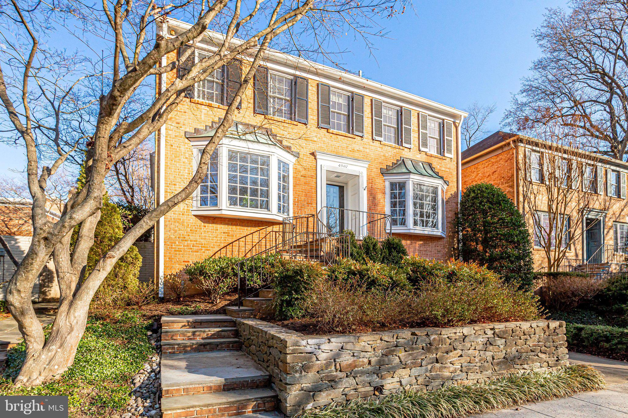 As you are ushered into this home , timeless features are equal parts welcoming and elegant, and the grand foyer, sets the stage for all that follows -- nearly 5,000 sf of dramatic high-quality living . Situated on a gorgeous private lot in highly sought after Overlook, this center hall colonial offers functional spaces, large enough for entertaining in style, yet remain comfortable for daily living. Wide entryways off the foyer lead into the living and dining rooms, which are charm personified, and offer the ability to entertain a gathering with ease.
The formal living room is a charmer with a large bay window, the home's first (of 4) fireplaces, flanked by built-in shelving and cabinets. Another large bay windows highlights the large, elegant dining room with chair rail and crown molding and a new chandelier. A spacious, renovated half bath is also on the main level with new flooring, vanity, mirror & lighting., and the eat-in kitchen is in the heart of this home, and the traffic flow is conducive to entertaining in style.
Plentiful space and warm-hearted appeal is found in the sprawling, impressive, light-filled family room at the rear of the home with a wall of built -in shelving, fireplace with mantle, and 2 sets of over-sized sliding glass doors providing delightful views of the rear yard.
Three large bedrooms are found on the upper level level; one en suite, and the others conveniently share an updated bath (jack-and- jill ). The owner's suite is huge and light-filled, with lots of closet space, and a full bath, offering a dressing area, and new dual vanities, mirrors and light fixtures.
The lower level is home to a desirable recreation room with brick fireplace, and an updated half bath. A massive storage room offers a laundry area, utilities and space for rooms!
Extensive hardscaping has created an exquisite backyard oasis, where hosting a summer soiree, holiday gathering or merely playing host to quiet family times delights. The surrounding brick wall offers privacy for the enclosed, expansive slate patio/yard, with a functional, attached brick (4th) fireplace.
All of this and situated in the desirable neighborhood of Overlook, offering a community pool, beautiful walking paths and play area, and just steps to the Little Falls Stream Valley Park, and close by Capital Crescent Trail and Spring Valley Shopping Center. NOT to miss!