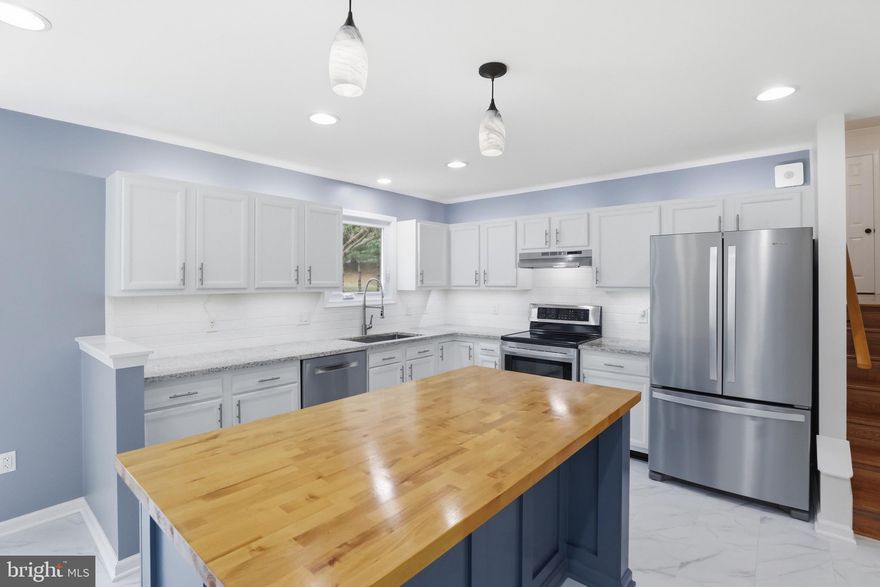 Finding a home that is this updated, this move-in ready, and sitting on such a large private lot at this price point is incredibly rare. Simply put, buyers will be hard-pressed to find anything that compares.

 From the moment you walk inside, you’ll immediately feel the care and thoughtful upgrades that make this property stand out from anything else in its price range.

The main living area welcomes you with a warm and inviting atmosphere that flows seamlessly into the fully upgraded kitchen, truly the heart of the home. Designed for both everyday living and entertaining, the kitchen features stainless steel appliances,  under-cabinet lighting, and a massive oversized butcher block island perfect for gathering with family and friends. You’ll also love the abundance of cabinetry, incredible storage space, and the oversized pantry with custom shelving, making this kitchen as practical as it is beautiful.

Just off the kitchen, step outside to the gorgeous expansive deck, creating the perfect indoor-outdoor lifestyle. Whether you're hosting summer barbecues, enjoying quiet mornings with coffee, or unwinding in the evening, this space overlooks an incredible .40-acre private backyard that backs directly to parkland and walking trails, providing rare privacy and peaceful natural views.

Upstairs, the primary suite offers a comfortable retreat complete with a private en-suite bathroom and its own deck terrace, an ideal place to relax and enjoy the surrounding greenery. All of the bedrooms feature brand-new carpet and overhead ceiling fans, ensuring comfort throughout the home.

The lower level family room provides an additional gathering space full of character, highlighted by a stylish shiplap accent wall with custom lighting that creates a cozy yet modern feel. This level also includes an additional bedroom with its own en-suite full bathroom, making it perfect for guests, extended family, or a private home office setup.

The lower-lower level basement offers even more functionality with the laundry area and extensive built-in shelving, providing tons of extra storage space to keep everything organized.

Outside, the huge private yard offers endless possibilities for entertaining, play, gardening, or simply enjoying the peaceful setting backing to nature.