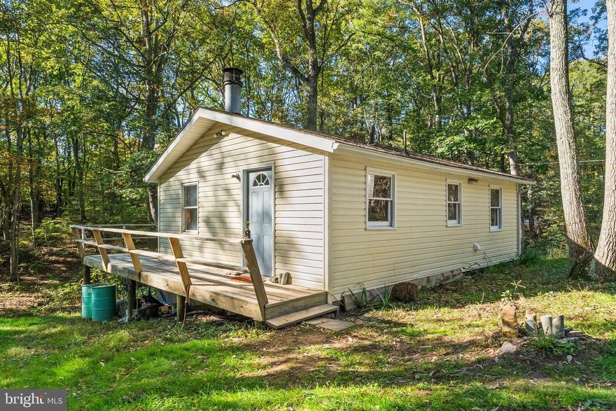 HUGE PRICE CUT!!!!! You won't want to miss this cozy one-bedroom, one-bath cottage nestled on over five acres of serene landscape, this delightful home offers the perfect retreat into nature. As you approach the home you'll be greeted by a solid wraparound porch, ideal for sipping morning coffee or enjoying evening sunsets.  Inside, the recently updated kitchen features modern appliances and stylish finishes, seamlessly blending functionality with comfort. The inviting living area offers a cozy fireplace, creating a warm ambiance for those chilly evenings. Step outside to discover a well appointed 8x12 fully functional shed for all your storage needs. Enjoy the soothing stream that runs through the back of the property, perfect for relaxation and enjoyment. Whether you’re entertaining friends or unwinding with a book, this home offers a harmonious blend of comfort and nature. Experience the tranquility and beauty of country living in this idyllic setting!