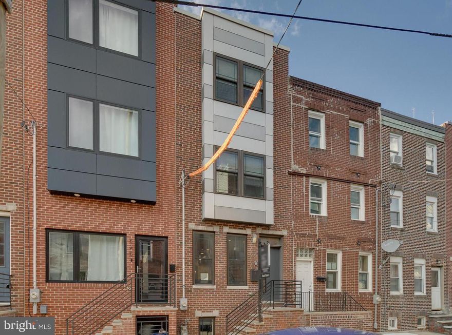 Available starting July 7th. Conveniently located a block off Snyder Ave in Philly's Wharton neighborhood, 623 Emily St is a newer construction 3 bed, 2.5 bath home offering a finished basement, a private patio, and a roof deck. Lined with other recent builds, a quiet block leads to the towering facade. Inside, the main level is bright, airy, and open. Two tall windows fill the living room with natural light, while high ceilings and hardwood floors stretch into the dining area. The modern kitchen is fitted with under-lit shaker cabinets, granite counters, stainless steel appliances, a tile backsplash, and an island with seating. Out back, the private patio is the perfect spot to create a serene garden oasis for grilling or lounging away from the city's hustle. The finished lower level has bonus space that could act as a media room or gym, a half bathroom, and the laundry. Up on the second level, you'll find bright, spacious bedrooms with great closets flanking a full bathroom off the hall. The third level is dedicated to the primary suite. It has a bright bedroom with backlit tray ceilings, dual closets, and an attached bathroom with a double vanity and a glass-enclosed shower. Topping off the home is an expansive roof deck, ideal for hosting family and friends! 623 Emily St's fantastic location earns a Walk Score of 92! It's a short stroll from the Bok Building on 9th St and neighborhood favorites along Snyder Ave like Chiquita's, Phở Duyên, and Mick Daniels. When you need some fresh air, Ford Playground and Mifflin Square Park are both close. Plus, nearby shopping on Columbus Blvd includes Target, Acme, Wine & Spirits, Ikea, and Lowes. There's also quick access to I-95 and South Jersey via I-76. Schedule your virtual tour today!