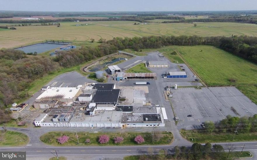 Upcoming Auction  May 4th @ 11am.
Open house and inspections to be on April 22 between 10 am to 1 pm.
Former poultry processing plant. Located on the eastern shore of Maryland less than an hour drive to the metro areas of DC and Baltimore. Ideal for manufacturing, processing, warehouse or other industrial uses. Loading areas, process rooms, office areas, free standing 131000 SF vehicle maintenance facility. Wastewater treatment system in place. Office space is a 2-story separate building. Features private wells with a small septic system. Property has two waste water ponds and water treatment plant .; one has a 10 million gallon capacity and the other a 3 million gallon capacity. Also included on the property is a sludge pond with a 1 million gallon capacity. The Property hold 7 seven private wells. Plant features 7 dock-high doors, double doors allowing forklifts to drive in at ground level, 16-18' ceilings and a separate truck maintenance facility. Total of 80 acres from two parcels.  solar farm would be the best use.