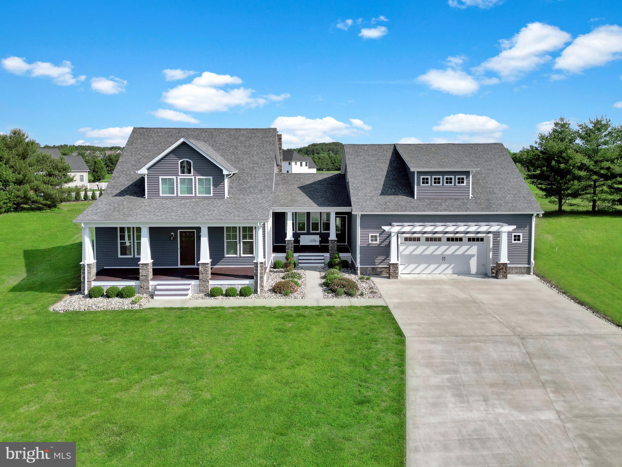 This stunning 4-bedroom, 4-bathroom custom-built home is perfectly situated in the highly desirable West Nithsdale community of Salisbury, MD. From the inviting covered front porch to the thoughtfully designed interior, this home blends timeless style with modern functionality. Step inside to an open-concept kitchen and living area ideal for entertaining and everyday living. The gourmet kitchen features a large island, gas cooktop with hood, double ovens, abundant cabinetry, a walk-in pantry, and a dry bar complete with a wine fridge—perfect for hosting. The spacious living room centers around a wood-burning fireplace, creating a cozy yet elegant ambiance. A dedicated office on the first floor provides a private workspace, while the large utility/laundry room includes custom built-ins for added convenience. Full bathroom also on the first floor.
Upstairs, retreat to the expansive primary suite with cathedral ceilings, a huge walk-in closet, and a spa-like bath featuring dual vanities, a soaking tub, and a walk-in tiled shower. A massive bedroom above the garage boasts its own private bathroom, while a two more bedrooms and bath complete the upstairs. Enjoy outdoor living on the covered back patio, ideal for relaxing or entertaining year-round. The conditioned crawlspace includes a dehumidifier for peace of mind, and the attached two-car garage is equipped with a 12,000 BTU propane heater, making it a functional space in any season. Don’t miss your chance to own this beautifully maintained, custom home in one of Salisbury’s most sought-after neighborhoods!