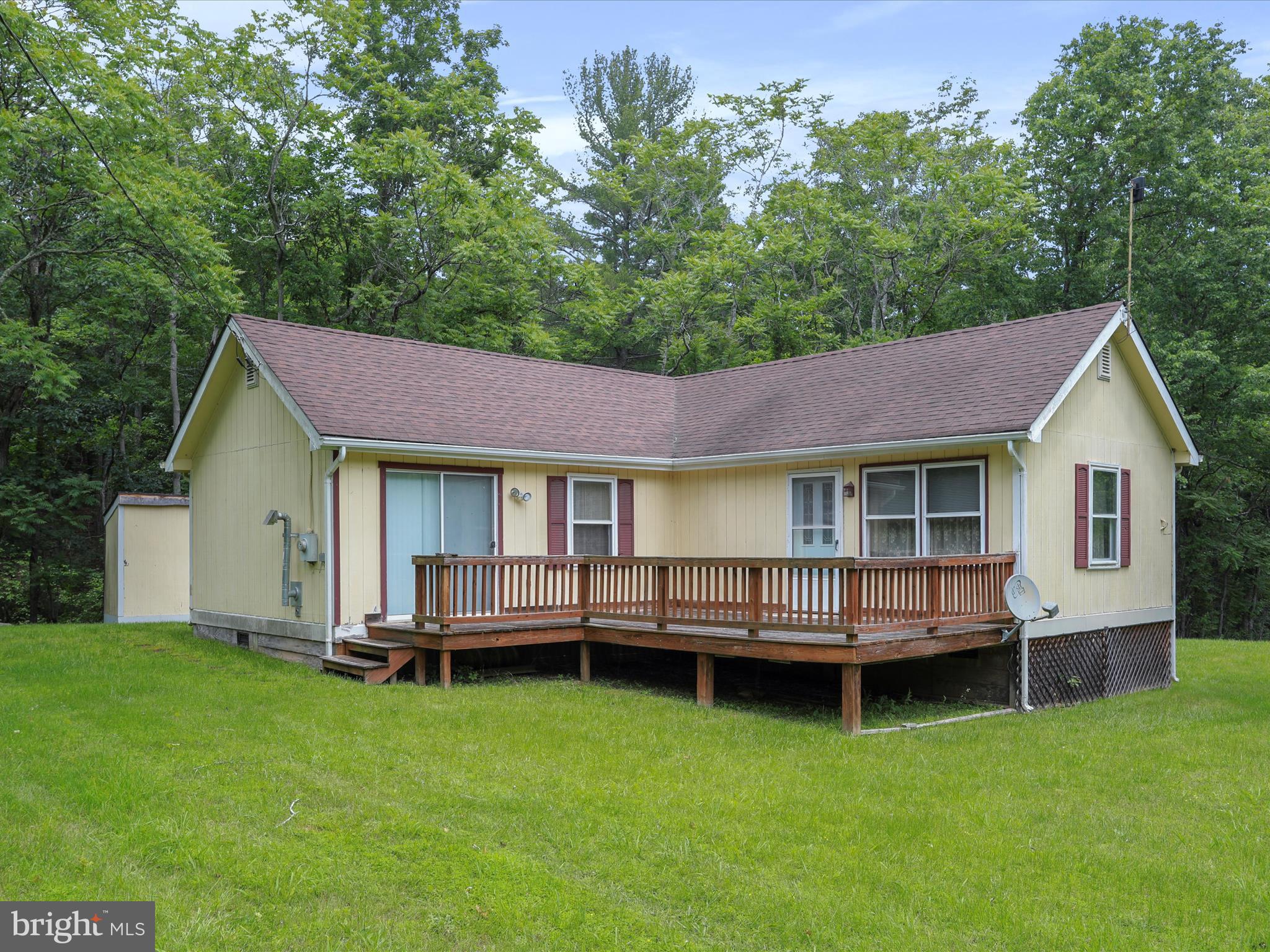 Hidden back in the quiet hills of Hampshire County, this no-nonsense country cabin offers just what you need—and nothing you don’t. Whether you’re after a weekend getaway or a full-time place to keep things simple, this one gets the job done. Set on 2.01 gently rolling acres, the cabin offers 896 square feet with 2 bedrooms and 1 full bath. It’s heated with electric baseboard and cooled with central air—easy to manage, low-maintenance, and ready to go. The layout is practical and efficient, with just the right amount of space to live comfortably without any wasted square footage. The cabin’s in good shape—it’s just not brand new. A few modern touches and minor updates could really elevate it. The structure is solid, the setting is peaceful, and the potential is clear. With a bit of vision and a weekend or two, this place could easily go from good to great. A storage building on the property adds extra utility—perfect for tools, gear, or anything else you want to keep out of the weather. Location-wise, you’re close to Route 50 and Corridor H, putting you about 45 minutes from Winchester, VA, and the I-81 corridor—and just two hours from the D.C. metro area. Far enough to leave the noise behind, but close enough when you need to make a run to town. Outdoor folks will appreciate the nearby North River and Short Mountain Wildlife Management Area—prime spots for hunting, fishing, hiking, or just stretching your legs under open sky. Bottom line: it’s private, it’s peaceful, and it’s priced right. If you're looking for a back-to-basics kind of place with real potential, this one's worth your attention.