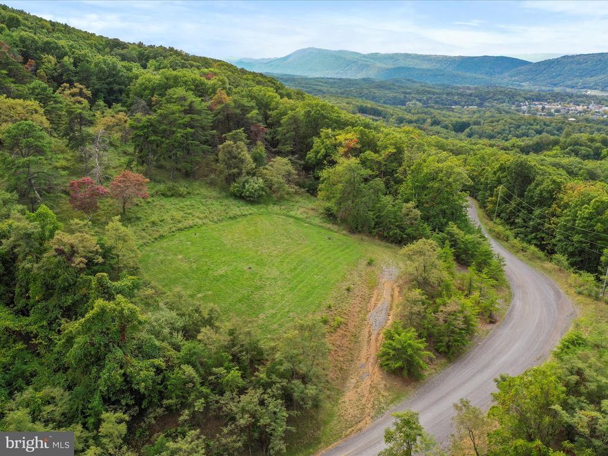 BUILD SITE AND PUBLIC WATER ON 10+ acres within minutes of downtown!  Come and take in the marvelous mountain top views from these lovely properties being offered for sale. *UPDATE* Fiber Optic Internet has been installed and is available at this location! Lot 5 boasts improvements such as an established driveway, fantastic views, a build site and public water.  Lot 13 is bursting with potential with easy access off of the road, public water, mountain views and an established path that moves through the top of the property. Both lots are being sold together. The location of the land is sought after with a balance of privacy and ample acreage with stores, downtown Romney, schools, farmer's markets, the beloved Potomac Eagle train and healthcare only minutes away. The gated community affords a warm sense of security. Not only is the land close to local amenities, but is an easy drive from areas such as Washington, D.C. and Northern Virginia. This is a must see!