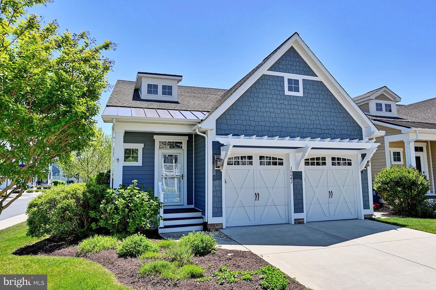 Nestled in the prestigious community of The Overlook, this exquisite coastal contemporary residence offers an unparalleled lifestyle of luxury and comfort. This corner lot property boasts a serene view of a tranquil pond, inviting you to unwind in nature's embrace. Step inside to discover an open floor plan adorned with crown moldings and engineered wood flooring, creating a warm and inviting atmosphere. The gourmet kitchen is a chef's dream, featuring upgraded countertops, a spacious island, and stainless steel appliances, including a built-in microwave and wall oven. The dining area adds an extra touch of elegance, perfect for entertaining. With four generously sized bedrooms and three and a half bathrooms, including a luxurious walk-in shower with dual shower heads, this home is designed for both relaxation and functionality. The main floor laundry and entry-level bedroom enhance convenience, while the cozy living area sets the perfect ambiance for gatherings. Enjoy outdoor living on the expansive patio or balcony, ideal for morning coffee or evening sunsets. The community amenities include a large walk-in pool, fitness center, meeting area, locker rooms and a kayak launch and boats docks, ensuring a lifestyle of leisure and enjoyment. Additional features include a two-car attached garage and lighted parking. This property is not just a home; it's a sanctuary where luxury meets tranquility, offering an exclusive lifestyle that is truly one-of-a-kind.