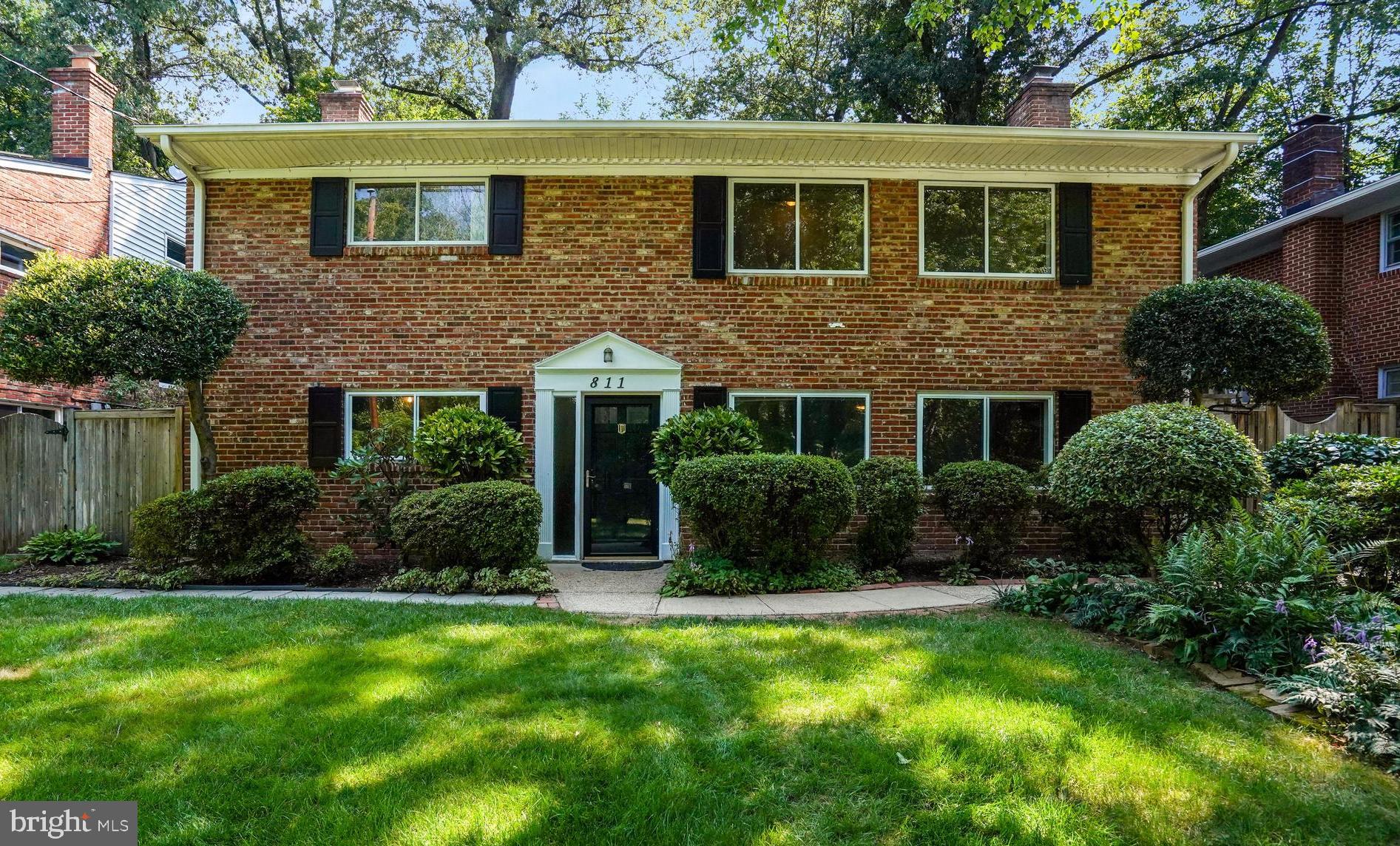 Classic 5BR/3BA offers the perfect blend of charm, privacy, and location. Timeless red brick construction with warm, varied tones and twin chimneys offer architectural balance. Set on a meticulously landscaped lot, the property showcases extensive hardscaping, including stone columns, a coordinating retaining wall, and an exquisite tiered bluestone patio. Enjoy front-facing views of mature trees and a quiet stream that bring a sense of calm upon arrival. The backyard offers a private, intimate setting nestled beneath a graceful Japanese maple and crape myrtle. A rare opportunity in a sought-after setting. Nothing else compares!