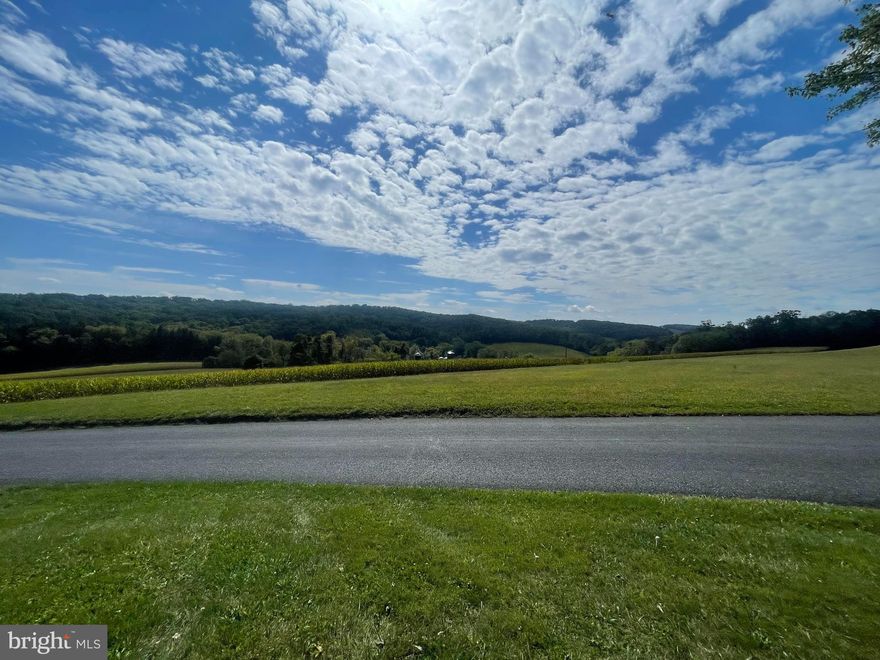 Carroll County Charm with Incredible Views

Opportunity awaits with this solid brick-front ranch, lovingly held by the same family for over 64 years since it was built. Set on nearly half an acre, this home offers 4 bedrooms and 3 full baths, including 2 full baths on the main level, along with approximately 1,350 square feet above grade is now ready for its next chapter.

The main level features a spacious living area with hardwood floors that extend through the living room, hallway, and three of the bedrooms. The main level has been freshly painted, offering a clean and refreshed feel throughout. The eat-in kitchen provides plenty of cabinet and countertop space, making it both functional and inviting for everyday living. The home is also equipped with central vacuum for added convenience. A rear entry area provides a practical transition space, ideal for bringing in groceries or everyday use.

The layout includes a private primary suite with its own full bath and walk-in closet on one side of the home, with three additional bedrooms and another full bath on the opposite side. A pull-down attic provides convenient additional storage.

The walkout lower level adds approximately 988 additional square feet, partially finished and full of flexibility, including a wood-burning stove, bonus full bath, and space ideal for storage, hobbies, or future expansion.

Car enthusiasts, hobbyists, or those needing extra space will appreciate the detached two-car garage with workshop, along with two separate driveways offering flexible parking for 8–10 vehicles.

This home reflects years of long-term ownership and offers solid construction, with important systems already addressed, including updated electrical work, roof replaced (2022), water heater (2018), and a recently tested well, water quality, and septic. While some features remain original and the home would benefit from cosmetic updates over time, it provides a strong foundation for buyers looking to personalize and build value.

The setting is truly special. Enjoy sweeping views of Carroll County’s rolling farmland from your yard, patio, or driveway, paired with a sense of privacy and calm that’s hard to find. It’s the kind of place where you can start and end each day feeling grounded and at peace.

With solid bones, newer roof, updated electric and plumbing, generous space, and room to grow, this home presents a rare opportunity to bring your vision to life. Being sold as-is, it offers incredible potential in a serene, elevated setting. 

*Water yield, septic, and water quality were tested March 27, 2026.  Septic system is functional, water tested clean, and the well flow has been consistent and supports normal household use and electric and plumbing updated, exterior painting around the home, primary toilet replaced, oil tank was recently filled.  Wood stove in lower level is inspected and cleaned annually.

Create your legacy and begin your next chapter with this once-in-a-lifetime opportunity.