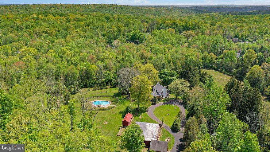 On over 36 PRIVATE ACRES OF PRESERVED FIELDS AND WOODLANDS , this lovely Bucks County farm sits at the end of a long drive, where history and convenience blend effortlessly. The quintessential BUCKS COUNTY STONE COLONIAL had its beginnings as a 1750’s SETTLER'S COTTAGE, on land that dates back to a WILLIAM PENN LAND GRANT. TOHICKON CREEK borders the property and offers the perfect place to fish and enjoy.
A picturesque representation of its Bucks County heritage, there are pumpkin pine floors, period moldings, EXPOSED CEILING BEAMS, deep windows, and a BUTTERFLY STAIRCASE. A large, GREAT ROOM addition adds charm, open space, skylights, an EXPOSED STONE WALL and windows overlooking the stone bank barn. On the first floor is a full bath, large living and dining rooms, newly renovated kitchen, and a cozy winter family room with WALK-IN FIREPLACE and second floor playroom. On the second floor there are four charming bedrooms, all with original details, and a hall bath.
An IN-GROUND POOLis nearby, inviting family and friends to visit. A two car garage is attached to the bank barn. At every turn, historic character and ageless dignity are evident, in a preserved Bucks County property, appreciated and tended for generations.
Come walk the wooded trails, sit and enjoy the SERENE VIEWSand contemplate the beauty of nature... all just minutes from every convenience.