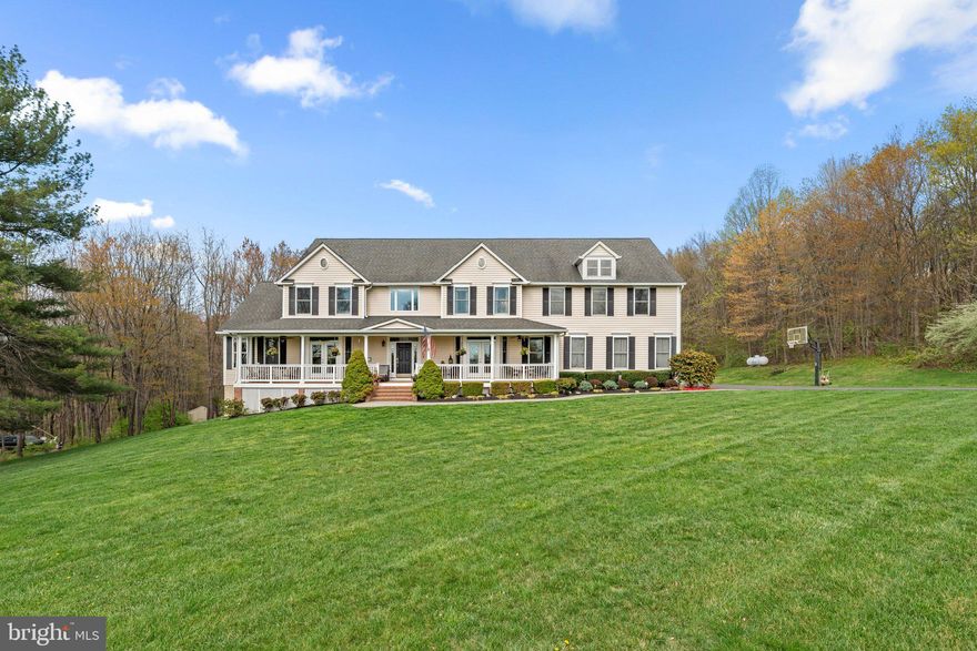 This stunning custom-built estate is perfectly situated on a private 5.6-acre lot, backing to hundreds of acres of undeveloped wooded land for ultimate privacy and natural beauty. A sprawling front porch welcomes you with breathtaking rolling countryside views, creating a peaceful retreat while still being conveniently close to shopping, dining, and major commuter routes. With 7,800 sq. ft. of finished living space across three levels, this move-in-ready home offers 8 spacious bedrooms, 5 full bathrooms, and 1 half bath. The gourmet kitchen is a chef’s dream, featuring granite countertops, large island that seats 10 and includes plenty of storage below, stainless steel appliances, a large pantry, and a cozy table space sitting area. The main level also boasts a formal dining room, a sunroom filled with natural light, and a warm and inviting family room complete with built-ins, stone accents, and a gas fireplace. A dedicated laundry room with cabinets, washer, and dryer adds convenience to daily living. Upstairs, the owner’s suite is a true retreat, offering a tray ceiling, a private gas fireplace in sitting room, an enormous walk-in closet, and a luxurious en-suite bathroom with granite countertops, a large step-in shower, and a whirlpool tub. An adjoining bonus room provides the perfect space for a home office, sitting area, or workout space. The upper level also includes three additional generously sized bedrooms one of which has its own full bathroom and all with ample closet space. The fully finished lower level is designed for entertainment and relaxation, featuring a theater room, a large storage room, and 2 additional bedrooms with a full bathroom and gas fireplace and kitchenette with granite countertop and washer dryer hook-up Outside, the property is just as impressive, featuring a 3-car garage, a large driveway with additional parking pad, an additional gravel driveway with field access and additional parking with (2) 30 amp hookups and (1) 50 amp hookup RV pad, beautifully landscaped grounds surrounded by mature trees. Whether you’re looking for a peaceful retreat, a multi-generational living space, or a home designed for entertaining, this estate offers it all. Don’t miss this rare opportunity to own a truly one-of-a-kind property—schedule your private showing today!