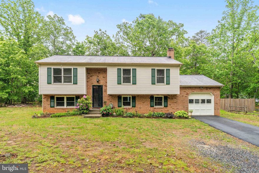 ✨ Welcome home to this beautifully maintained residence, perfectly tucked away on a half acre corner lot- in a peaceful, nature-filled lake community. 🛶 
 Offering 4 bedrooms, 3 full bathrooms, and a garage for all your storage needs. 🚘 
This home combines modern comfort with thoughtful upgrades and a warm, inviting atmosphere. Upstairs you will find a completely renovated kitchen with quartz counter tops, all new kitchen cabinetry, farmhouse style sink, stainless-steel appliances, and new flooring throughtout. 
The formal dining room right off the kitchen is great for family gatherings-- & The spacious living room boost with natural filled sunlight. ☀️ 
Enjoy the large primary bedroom & the convenience of the en suite 🚿 . On this level you will also find two additional generously sized bedrooms & another full bathroom. 🛁 Privacy & comfort for all. 🛋️ 
Step outside to enjoy the fenced backyard-- backing to woods, 🌲 creating a serene and quiet setting. 
Perfect for grilling out, 🍔 or simply relaxing while taking in the natural surroundings. 🍃 🌳 
Downstairs is a standout feature, offering incredible versatility with ample storage, expansive full bedroom and en suite 🚿, fireplace for those cold winters 🔥,recreation space, home gym, or guest retreat. 
Additional big ticket item upgrades include newer roof, hot water heater & HVAC system approx 5-6 years of age. This amenity-rich community brings vacation vibes right to your doorstep with access to a community pool, scenic lake, beaches, walking trails, playgrounds, and sports courts—all designed to make every weekend feel like a getaway. Conveniently located just minutes from everyday grocery stores, wineries, dining, and commuter routes. This home offers the perfect balance of privacy, space, and modern upgrades, an easy place to live, gather, and create lasting memories. ☕️ 📕 
Schedule your showing today! 📲