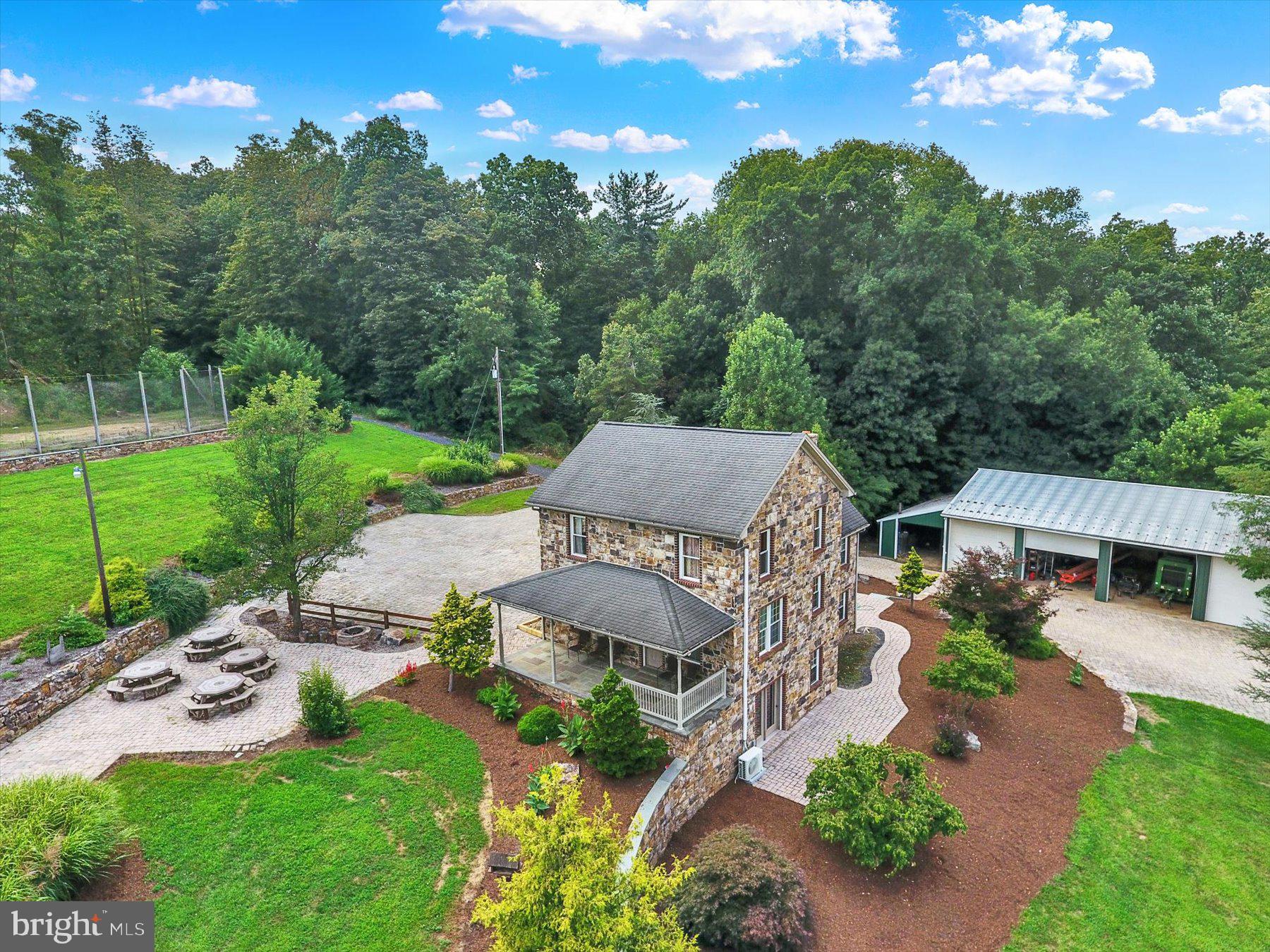 This property is going to onsite auction 10/15/2025 at 3:00 PM and is being sold with reserve. LISTED PRICE IS ONLY A SUGGESTED OPENING BID AND IS NOT INDICATIVE OF THE FINAL SALES PRICE WHICH WILL BE BY SELLER CONFIRMATION DAY OF AUCTION. Terms: Down payment of $50,000 required day of auction. Settlement on or before 12/15/2025. Transfer taxes to be paid by buyer. Real Estate taxes shall be prorated......
Discover a rare opportunity to own 67.5 acres in scenic Perry County, featuring a 3,189 sq. ft. stone home with 5 bedrooms, 4 baths, and 2 kitchens. Currently a popular cabin retreat, this property borders the Shermans Creek and offers a full walkout basement, multiple porches, and patios for outdoor enjoyment. As a previous offsite showroom for AH Reiff, the home is surrounded by extensive hardscaping, including a paved driveway, a paver parking area, paver patios with picnic tables, and flagstone walkways.
Enjoy resort-style amenities with a hot tub, impressive pavilion featuring an outdoor kitchen, volleyball/pickleball court, and children’s play area. Outbuildings include a 22' x 22' detached 2-car garage and a 38' x 80' equipment shed. At the top of the ridge, a large open field is perfect for farming or food plots, and you’ll find a large enclosed tree stand in addition to an off grid 435 sq. ft. cabin with a front porch and outdoor fire place.
Approximately 17 acres of fertile tillable ground are complemented by mature woodlands, with a recent survey ensuring clearly marked boundaries. Located near Fowlers Hollow, Big Spring, Little Buffalo, and Colonel Denning State Parks, this property blends income potential, farming capability, and year-round recreation in one exceptional package.