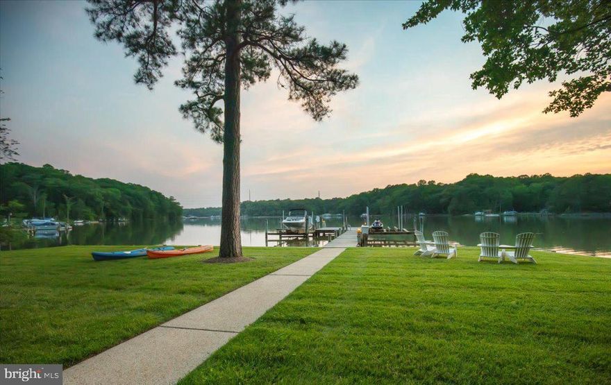 **PERRY POINT ON ST. LEONARD CREEK:** A premier 6.4-acre deep-water sanctuary along the shoreline of St. Leonard Creek. The property is incredibly private, offering placid and protected water. Wildlife is abundant with bald eagles, osprey, herons, and more. Located just an hour from Capitol Hill, the 4,300 SF contemporary-coastal home offers the ultimate year-round Chesapeake lifestyle. Enjoy four-season scenery plus boating, fishing, and crabbing right off the private pier, which features two 12,500 lb boat lifts. This section of St. Leonard Creek is perfect for water sports in the cove without the activity of the larger creek. Inside, a dramatic two-story glass wall showcases commanding water views. The house has a rich exterior with natural stone and copper guttering, downspouts. The interior has just been painted throughout, and most of the flooring is wide-plank white oak hardwood and slate. The kitchen in this open-concept plan is a chef's dream with custom cabinets and water views from every angle. Retreat to the upper-level owner's suite, where mahogany doors open to more wide-plank white oak floors and a deluxe spa bath with heated flooring...not to mentionh spectacular creek and property views! Guests will enjoy the three additional bedrooms and the legendary “Perry Point Ale House” on the lower level, featuring a 4-tap kegerator, ice machine, and a retractable HD cinema screen for game nights. Outdoor living is unmatched, featuring an expansive, one-of-a-kind bulkheaded flat lawn at the water’s edge—the perfect stage for crab feasts, tent parties, and sunset cocktails. The sale includes a Polaris Ranger 4x4 ATV and a massive live-edge California redwood table for 10. There is a second private well and electric for the waterfront improvements. All major inspections (well, septic, UST, WDI) already passed and certified in fall of 2025 and this home is ready for closing.