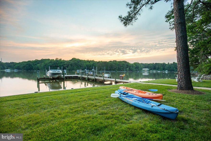 **PERRY POINT ON ST. LEONARD CREEK:** A premier 6.4-acre deep-water sanctuary along the shoreline of St. Leonard Creek. The property is incredibly private, offering placid and protected water. Wildlife is abundant with bald eagles, osprey, herons, and more. Located just an hour from Capitol Hill, the 4,300 SF contemporary-coastal home offers the ultimate year-round Chesapeake lifestyle. Enjoy four-season scenery plus boating, fishing, and crabbing right off the private pier, which features two 12,500 lb boat lifts. This section of St. Leonard Creek is perfect for water sports in the cove without the activity of the larger creek. Inside, a dramatic two-story glass wall showcases commanding water views. The house has a rich exterior with natural stone and copper guttering, downspouts. The interior has just been painted throughout, and most of the flooring is wide-plank white oak hardwood and slate. The kitchen in this open-concept plan is a chef's dream with custom cabinets and water views from every angle. Retreat to the upper-level owner's suite, where mahogany doors open to more wide-plank white oak floors and a deluxe spa bath with heated flooring...not to mentionh spectacular creek and property views! Guests will enjoy the three additional bedrooms and the legendary “Perry Point Ale House” on the lower level, featuring a 4-tap kegerator, ice machine, and a retractable HD cinema screen for game nights. Outdoor living is unmatched, featuring an expansive, one-of-a-kind bulkheaded flat lawn at the water’s edge—the perfect stage for crab feasts, tent parties, and sunset cocktails. The sale includes a Polaris Ranger 4x4 ATV and a massive live-edge California redwood table for 10. There is a second private well and electric for the waterfront improvements. All major inspections (well, septic, UST, WDI) already passed and certified in fall of 2025 and this home is ready for closing.