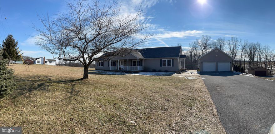 Elegant Rancher with over 2300 sq ft on the Main Level, situated on 1.25 acres of beautiful countryside. Private in-law suite on Main Level  with separate kitchen bath and entrance.  Beautiful hardwood flooring, Updated kitchen with Stainless Steel Appliances and sliders to rear patio.  This spacious open floor plan  opens to 3 covered porches  you can enjoy the Sunrises and Sunsets!!! Oversized 2 car Garage and unfinished english cellar with new never rot french doors, Pellet stove and great storage . Easily finished with tall ceilings. 
In- law suite has separate hot water heater and HVAC .   
Updates  include : Roof 2021, Well pump , kitchen and Pellett stove 2020.