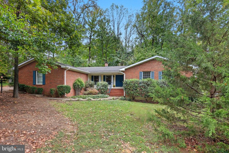 Tucked away in a quiet, wooded, and hidden neighborhood, this charming one-level home offers the perfect blend of privacy, space, and convenience. Just minutes from major highways, shopping, dining, and downtown Fredericksburg, it's an ideal location with a peaceful, retreat-like feel.

The heart of this home is the huge family room featuring a vaulted ceilings and skylights, as well as walls of windows and a gas fireplace that create a bright, open space filled with an abundance of natural light.  The open layout creates a seamless flow between living spaces and offers versatile areas that adapt to your lifestyle.
The spacious eat-in kitchen boasts elegant Silestone countertops, a high-end Jenn Air cooktop with a convenient grill feature, an oversized pantry for ample storage, and a breakfast bar perfect for casual dining or entertaining.
Flowing effortlessly from both the kitchen and living room, the screened-in porch invites you to savor your morning coffee while being serenaded by the gentle whispers of nature all around.

At the opposite end of the home, four spacious bedrooms offer a peaceful sanctuary for rest and relaxation. Each bedroom features generous closet space and ample windows that fill the rooms with natural light, creating bright and inviting personal retreats.

With a two-car garage, a functional layout, and a sought-after single-level design, in a neighborhood with no HOA,  this home is a rare find.