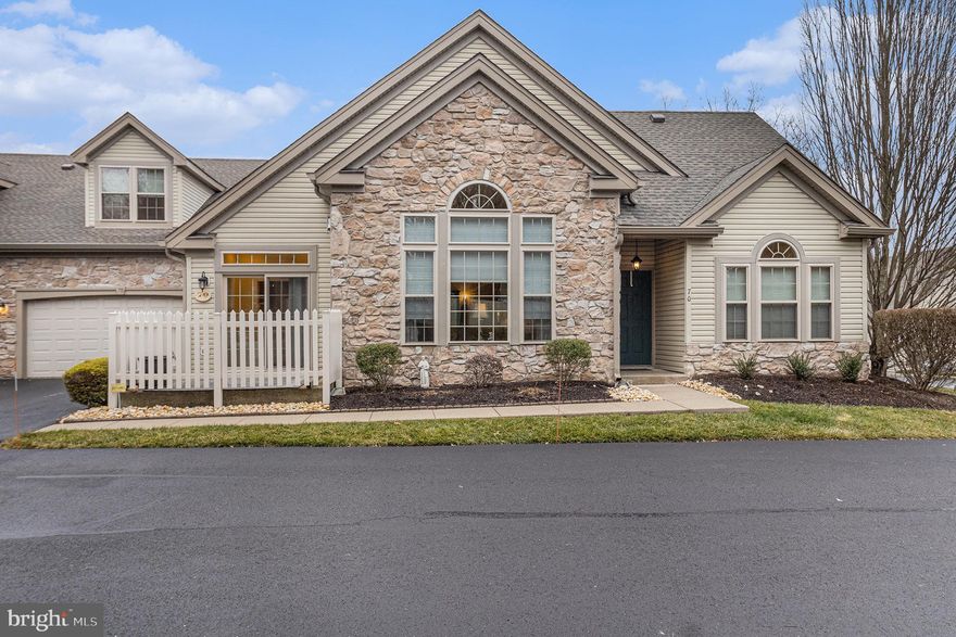 Welcome to this beautifully maintained end-unit home in the 55+ community of Legacy Oaks at Northampton, offering first-floor living with a finished loft in a desirable quad configuration.  Tucked away in a private setting, this home offers seclusion and tranquility.  Property is located in a non-drive-by area. Step into the hardwood foyer, where vaulted ceilings and elegant window designs immediately create a bright, welcoming feel. The spacious living room features hardwood floors, large windows, and an open layout ideal for everyday living or entertaining. The adjacent dining area flows seamlessly into the kitchen, which offers abundant cabinetry, generous counter space, and a functional layout with easy access to the private fenced patio. The first-floor primary suite is spacious and comfortable, featuring plush carpeting, a large window, ample closet space, and a private en-suite bath. A second bedroom and full hall bath on the main level provide flexibility for guests or a home office. Convenient first-floor laundry adds to the ease of daily living. Upstairs, the finished loft offers versatile space perfect for a family room, hobby area, or additional guest accommodations. Additional full bath in the is also in the loft area along with two large storage closets.  Stone exterior, two+-car garage, and low-maintenance living complete this elegant home designed for comfort, convenience, and carefree retirement living.  Home offers a new roof installed in 2025.