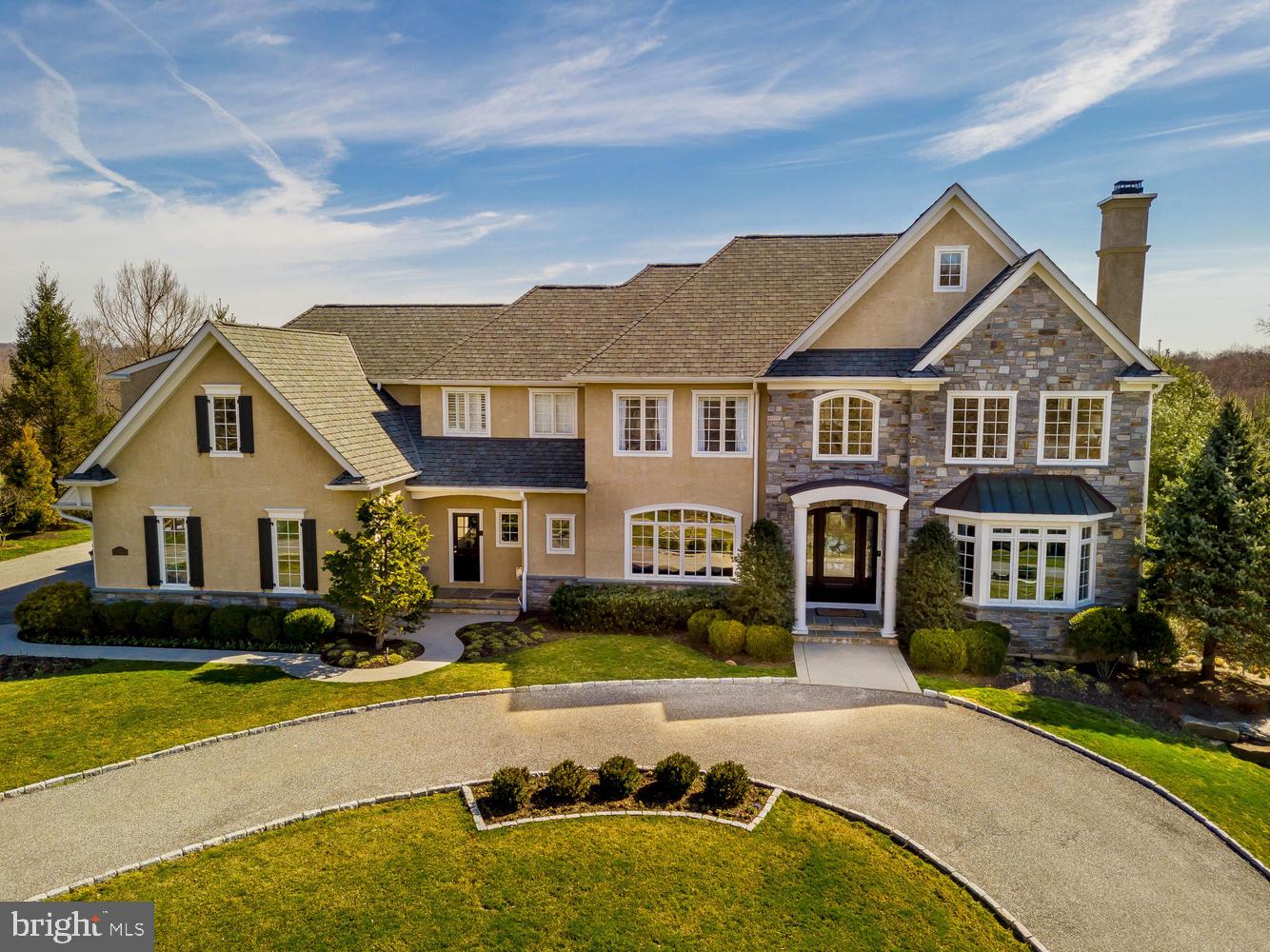Superb craftsmanship and timeless architecture are unrivaled in this 8,000 sf Moser built estate home nestled on over an acre in the picturesque and prestigious Water Mill community. Sophisticated elegance and style meet the rural surroundings and convenient location with quality appointments throughout this impressive residence. Extraordinary outdoor living & entertaining areas, easy to use AV systems, elaborate millwork, recess lighting with LEDs and extensive on site hardwood flooring are only the beginning. A private lane leads to a welcoming circular driveway with meticulous landscaping and stunning front door entrance. The grand center hall is flanked on the right by the living room with french doors leading to a study with custom built in bookcases with a relaxing sunroom behind; and on the left by the dining room with attractive moldings & butler's pantry. Custom chef's kitchen is the heart of the home with an abundance of glazed cabinetry, granite & limestone countertops with decorative tile backsplash, farmhouse sink, commercial grade appliances and a center island. This inviting open floorplan is spacious yet intimate, providing a wonderful flow from the warmth of the kitchen & light filled breakfast room into the oversized family room with vaulted ceilings, fireplace and built in entertainment center. An organizational area, command center and two powder room's complete this Level. Retreat to the luxurious Owner's Suite with a dressing area & two walk-in closets with custom organizers. The spa like bath boasts his & hers vanities with limestone counters, a soaking tub, walk in tiled shower with body jets and a private water closet. There are four additional bedrooms: 2 bedroom suites with a private bath and 2 bedrooms that share a bath Jack n Jill style, upper floor laundry room with wash tub and folding counter and loft/reading nook complete the upper level. Spectacular finished walkout lower level offers another entertainment/gathering area with cherry floors, gas fireplace, custom bar, 600 bottle temperature controlled wine room, home gym, sound proof music room and 2nd laundry room. There are several private outdoor living spaces on the flagstone patios with an entrance from the main level of the house or the lower level. Pick your perfect place for morning coffee, afternoon BBQ s, or just relax and enjoy watching a game on the outdoor TV under the pergola or listen to your favorite genre on the outdoor speakers. The beautiful gunite pool is heated and has a waterfall and hot tub that is always the perfect aquamarine color! This striking setting is enhanced by the pristine gardens and natural stone wall accents! This home has been meticulously maintained and is for the discriminating buyer who wants EVERYTHING conveniently located to the most sought after locations ... Downtown Media, the Main Line, Center City, Philadelphia Airport & sports complexes. Award winning Rose Tree Media schools along with some of the best private schools in the area which are in close proximity (Episcopal Academy & Baldwin). Plenty of boutique shops, restaurants, Whole Foods Market & Starbucks are just mins away. 4 car garage, zoned HVAC (NEW furnace 2018), generator, irrigation System. PLUS All appliances, window treatments, pool/patio furniture and planters, and AV equipment will remain with the house! What more could you ask for?