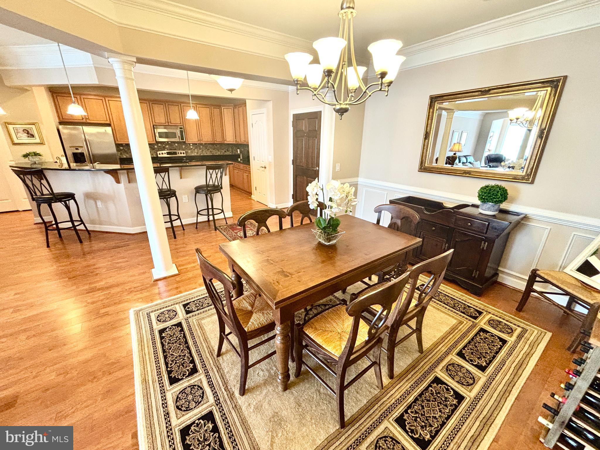 Experience upscale living in this stunning one-level penthouse condo, ideally situated in the vibrant heart of Downtown La Plata. Boasting just under 2,000 square feet, this spacious 3-bedroom, 2-bath home combines a split design for maximum privacy. Step into a bright and open layout featuring a gourmet kitchen with expansive wall-to-wall granite counters, a large center island with barstool seating, abundant cabinet space, and two pantries for storage—perfect for both entertaining and everyday living. The inviting dining room is framed with elegant columns, flowing seamlessly into a cozy living room with fireplace, which opens into a flexible space ideal for a home office, reading nook, or workout area. The primary suite offers a tranquil retreat with its own bonus sitting area, walk in closet with built in shelving and a spa-like ensuite bath complete with a walk-in shower, tub/shower combo, and a dual sink vanity. Two additional bedrooms share a spacious hall bath with a tub/shower combo and dual sink vanity. A large laundry room with extra storage and two additional private hallway closets provide plenty of organizational space. Enjoy the convenience of an attached garage, additional parking space, and access to community amenities including a pool, pet-friendly play yard, clubhouse with fitness equipment, and nature-filled walking paths. Just minutes from shopping, dining, and commuter routes—this condo offers the perfect blend of location and luxury.