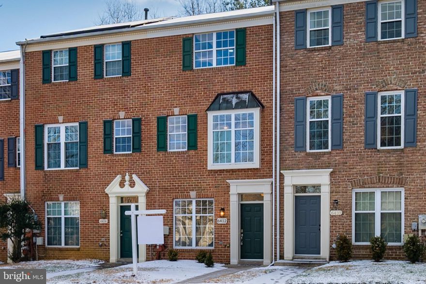 Welcome to 6412 Wind Rider Way, an amazing brick front townhome thoughtfully upgraded with on-trend fixtures and finishes throughout.  Fresh neutral paint, new luxury vinyl plank flooring and upgraded carpeting are the perfect foundation for this special home.  The eat-in kitchen features 42" white cabinetry, upgraded stainless steel appliances, a large pantry and brand new quartz countertops.  The sunny breakfast area is the perfect spot for morning coffee and leads to the private deck.  Relax or entertain in the spacious main level living room with 9' ceilings and recessed lighting. Upstairs you will find two large bedrooms and two beautifully upgraded baths.  The primary bedroom offers a large walk-in closet and a luxury bath with a custom frameless shower and a large soaking tub. The versatile lower level offers a third bedroom or office, a completely upgraded full bath and a large family room with a slider to the fenced yard and private patio. This great home is located on a premium lot backing to woods and is ultra convenient to walking trails, shopping, and major commuter routes.