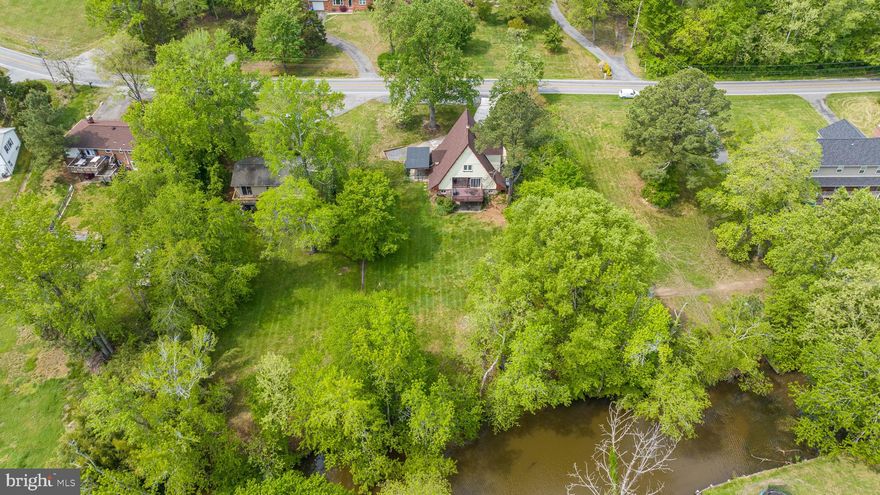 Introducing a remarkable real estate home that is far from your typical cookie-cutter house. This unique property embodies the charm of a Swiss chalet A-frame design, complemented by a picturesque 18x16 boathouse on the serene Canal of the Port Tobacco River. Perfectly suited for water enthusiasts, it boasts an enviable location just a stone's throw away from the marina and nestled within a vibrant water village community.
This home is a haven for those who enjoy canoeing, kayaking, or paddleboarding. Don't let its unassuming facade deceive you; with over 3700 square feet spread across three finished levels, this residence offers ample space for comfortable living. The open floor plan and large picture windows invite abundant natural light, creating a bright and airy atmosphere. The main floor has been fully remodeled, showcasing meticulous attention to detail, including beautiful custom-built balusters and wrought iron railings.
Both bathrooms have been upgraded , featuring handcrafted marbles and ceramic finishes, add a touch of elegance to the home. Additionally, the 18 x 16 boathouse provides a stunning space to relax and enjoy the waterfront views. With some fresh paint throughout, this property is ready for you to make it your own.
 Its ideal location near the marina and within a water village community makes it a dream come true for water enthusiasts. With its spacious layout, open floor plan, and attention to detail, this home offers a unique living experience that sets it apart from the ordinary. Lets not forget the brand new roof. Easy commuter route into DC, Virginia, and local military bases and only minutes away to parks, walking trails, shopping, restaurant, schools, Post office and the University of Maryland Charles regional medical center.