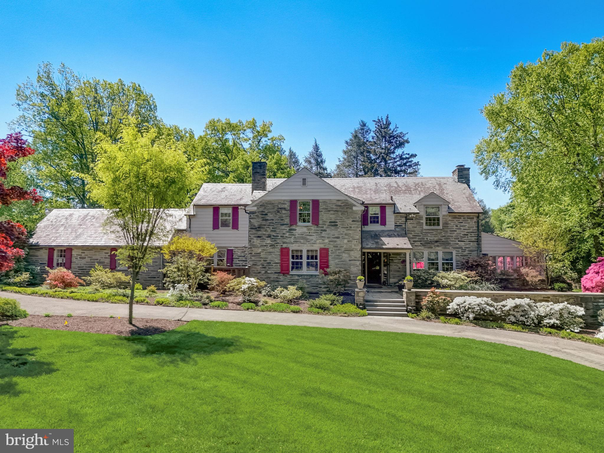 Situated on 1.3 acres, this stunning stone colonial residence epitomizes the seamless fusion of timeless sophistication and contemporary charm, boasting five bedrooms, gleaming hardwood floors throughout and an array of entertainment spaces, both indoors and out.

Spanning an impressive 3800 square feet (+ an additional 1200 sq ft in basement), the interior of this distinguished abode is a masterpiece of craftsmanship and attention to detail. Upon entering, you're greeted by the spacious and inviting living room, setting the tone for elegant living. The seamlessly integrated culinary space and family room fosters effortless connectivity, ideal for today's dynamic family lifestyle. The thoughtful renovation of the laundry/mudroom further enhances convenience, offering ample custom built-in storage and easy access from the garage to the heart of the home.

The well executed renovation of the kitchen included high-end custom cherry wood cabinets, granite countertops, built-in Sub Zero refrigerator, double convection oven, warming drawer, and Fisher & Paykel Dishdrawer dishwasher.  A separate bar sink with filtered water provides additional space for food prep or entertaining. Just off the kitchen is a bright and spacious dining room perfect for hosting intimate dinner parties or large holiday gatherings.

Continuing the journey through this refined residence, discover a versatile array of living spaces, including a sunlit living room adorned with a wood burning fireplace and back-lit corner built-ins, and a captivating sunroom offering endless possibilities for work or relaxation. Currently used as an office, bedroom #5, presents flexible options for a bedroom or home office, offering ample space and endless potential.

Ascending the staircase, four generously proportioned bedrooms await, each providing a serene sanctuary for rest and rejuvenation. The owner's suite exudes tranquility with its spacious bathroom and abundant closet space, while bedroom #4 offers its own private oasis with French door access to a charming balcony overlooking the lush grounds below.

The lower level of this exceptional residence has been thoughtfully updated to enhance the entertainment experience, featuring a versatile rec room with 8' ceilings, a wood-burning fireplace, ample walk-in storage closets that are outfitted for smart storage needs, a dedicated crafting or gym space, and an opportune full bath with soothing steam shower.

Stepping outside through the double Dutch door, the enchantment continues with sprawling lawns, mature trees, manicured gardens, a pond garden, and expansive patio space, creating an idyllic setting for outdoor gatherings or peaceful moments in nature.

Nestled in one of Rydal's most coveted neighborhoods, this extraordinary property offers the perfect balance of classic elegance and modern comfort. With its unparalleled charm and gracious living spaces, this is more than just a home—it's a lifestyle. Don't miss the opportunity to make this exceptional property your own.