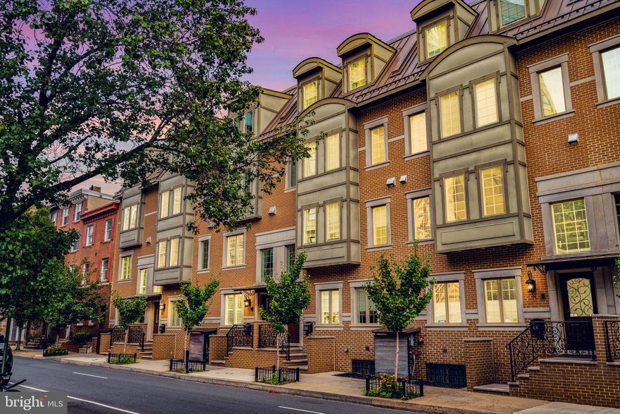 Welcome to The Lombard Estates: Located just a few blocks from the coveted Rittenhouse Square area on a tree-lined street, this gorgeous light-filled home is move-in ready! This is one of 11 homes located in this coveted gated community. Enter the home into a welcoming foyer where you may also access the attached 2-car garage. Head down from here to a fully finished basement complete with a wet bar, full bathroom,  and oversized storage closet. Step up to the second floor to an open living room and dining room complete with gas fireplace and Juliet balcony. The chef's kitchen has quartz counters, Viking appliances, an oversized island, and a cozy window bench! The third floor has two bedrooms and a laundry room. Both bedrooms have their own en suite bathrooms. NOTE: One of the larger bedrooms can easily be split into two bedrooms for more room. The master suite has an entire floor to itself with an en suite 5-piece bath with radiant floor heat and a walk-in closet. Off the master suite is a wet bar conveniently located off the first of the two outdoor decks. From the roof deck, you can enjoy magnificent views of the Philadelphia skyline and rivers, but has an outdoor kitchen and TV! This impeccable home has many other wonderful features throughout it including hardwood floors, dual HVAC, a video intercom system, built-in speakers, and more. The property is located in the Greenfield School District and only a short walk to CHOP, UPenn, Comcast and Center City! Floorplans available.