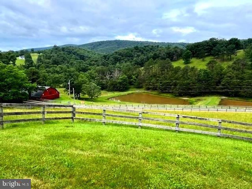 DON'T MISS THIS STUNNING FARM ON  71+ ACRES, UNRESTRICTED. THIS FARM HAS IT ALL!  3 SPRING-FED PONDS, FIELDS FOR GRAZING, AND AN OVER-SIZED BARN, WITH ELECTRIC AND PLENTY OF ROOM FOR ALL TYPES OF FARM EQUIPMENT.  IT HAS ELECTRIC FENCING.  THE BRICK HOME WAS BUILT IN 1978. THE MAIN LEVEL IS 1,106 SQ FT. AND THE BASEMENT IS 1,106. TOTAL SQ. FT. 2,212.  THE BASEMENT IS PARTIALLY FINISHED, WITH FULL BATH AND BEDRM.  YOU'LL FIND ANOTHER SPRING-FED POND, SURROUNDED WITH TOWERING PINES, ON THE SIDE OF THE HOME, TO THE LEFT OF THE DRIVEWAY.    IT'S A PRISTINE PROPERTY.  THERE'S A SEPARATE STORAGE BUILDING.  ALL OPTIONS:  RAISE CHICKENS, GOATS, HORSES!   CATTLE ARE IN THE LOWER PART OF THE FARM, WITH AN ABUNDANCE OF FRESH WATER IN 2 OVERFLOWING SPRING-FED PONDS.  THE MAIN LEVEL HAS AN OPEN KITCHEN WITH A DISHWASHER, REFRIGERATOR & STOVE/OVEN.  SPACIOUS AREA FOR THE COMBINED  KITCHEN & DINING AREA.  RELAX AND ENJOY THE BEAUTIFUL VIEWS FROM THE KITCHEN WINDOW.  TAKE IN THE FIELDS AND THE FORREST, WHICH SLOPES UPWARD.  ON THE SAME SIDE, AS YOU TURN ONTO THE DRIVEWAY, THERE'S A SMALLER, SPRING-FED 3RD POND.  IT'S NESTLED BEHIND THE PINES.  THE MAIN LEVEL HAS 2 BEDROOMS WITH A NEWLY REMODLED BATHROOM. THERE'S A VARIETY OF FLOORING: HARDWOOD, CARPETING & LINOLIUM.   THE LIVINGROOM HAS A BRICK FIREPLACE WITH A  WOOD-BURNING INSERT. THE LARGE WINDOW  OVERLOOKS THE STACKED PONDS & HILLSIDE, WHICH SLOPES UPWARD WITH EVEN MORE SCENIC VIEWS.   YOU CAN'T MISS SEEING THE BIG RED BARN!  THE FARM HAS 2 STACKED, SPRING-FED PONDS. THE PROPERTY IS FENCED.   FULL WALK-OUT BASEMENT W/ FULL BATH AND THE 3RD BEDROOM.  THERE'S PLENTY OF STORAGE IN THE BASEMENT. THE WASHER & DRYER CONVEY, ALONG WITH AN EXTRA REFRIGERATOR!  THERE'S A TOTAL OF 3 BDRMS AND 2 FULL BATHS:  MAIN LEVEL HAS 2 CARPETED BEDROOMS AND A BEAUTIFULLY REMODELED BATHROOM.  GRASSY LICK ROAD SEPARATES THE PROPERTY.    ENDLESS POSSIBILITES WITH THESE 71+ UNRESTRICTED ACRES!!  GREAT FOR HUNTING OR SIMPLY WATCHING THE WILDLIFE.  LOCATED JUST OUTSIDE OF ROMNEY, SURROUNDED BY SCENIC VIEWS ALL ALONG THE WAY!  LIVE THERE FULL-TIME OR MAKE IT YOUR PRIVATE  GET-AWAY FROM THE CROWDED METROPOLITAN AREAS .   JUST OVER 2 HOURS FROM  THE DC / METRO...TO THE MOUNTAINS OF WV!!