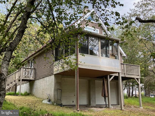 Secluded mountain chalet with full basement - built-in garage and room to expand; wood stove, wood floors, 3-season room, open floor plan