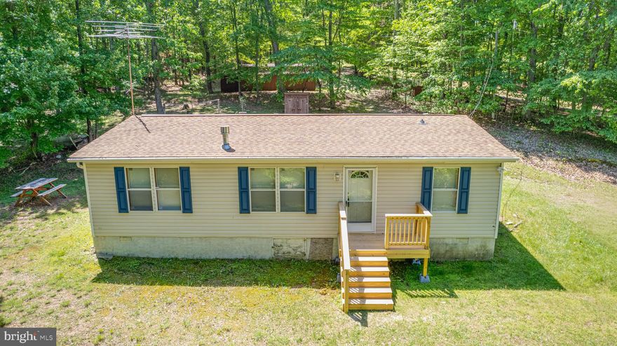 MULTIPLE OFFERS. BEST AND FINAL DUE SUNDAY, 5/19 4:00 PM. 
Welcome home to this charming and cozy rancher situated on 6.36 wooded acres in a peaceful, quiet neighborhood. This home offers 3 bedrooms and 2 bathrooms. Coming through the front door, you’ll step into the living area with adequate space for relaxing. The kitchen provides ample storage and space with cabinets, a built-in hutch, and a dining area. The laundry area is just off the kitchen. On either side of the living room are the ensuite master bedroom and bath and two additional bedrooms and bathroom. The master bedroom features a walk-in closet and full bath with a soaking tub and a stand-up shower. Another convenient full bath is also just off the living room between the two bedrooms and adds to the home’s functionality. 
Step outside and enjoy tranquil views of wildlife and nature from the new quaint front deck. Imagine the views when the leaves change to their vibrant fall colors. The home features several outbuildings for storage, a workshop equipped with electric and a heating stove for projects and year-round use, a lean to for additional storage, and a fenced area complete with a chicken coop. With some updating, this home is the perfect little farmette or first home at an affordable price. Schedule your tour before it's gone!