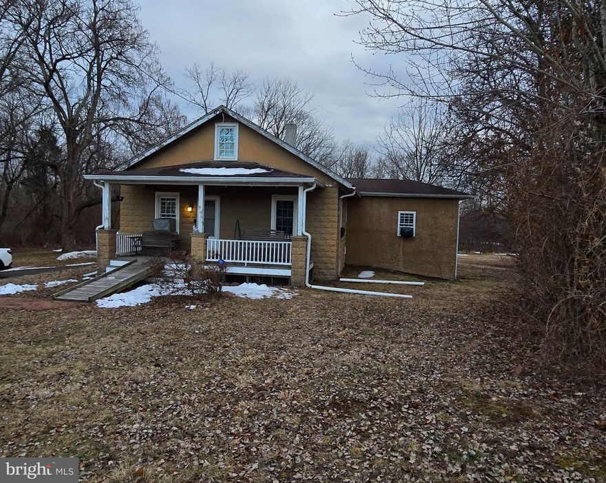Doylestown Zip Code! This "as is" 1.18 acre property has the space to expand  AND won't last long.  This 2 bedroom, 2 bath home is a work in progress.  Come check out this home that includes spacious front and back porches, detached 3 car garage, long driveway, built in 1935 and brimming with potential. With 2 spacious bedrooms and 2 full bathrooms, this residence offers a cozy yet functional layout, featuring a galley kitchen equipped with essential appliances, including a built-in microwave and electric oven/range. The unfinished basement presents an opportunity for customization or additional storage. The property backs to serene trees, providing a tranquil retreat from the hustle and bustle. Enjoy the expansive front and rear yards, perfect for outdoor gatherings or future enhancements. The detached garage, with ample space for three vehicles, adds significant value and convenience. With its prime location and investment potential, this property is ideal for those looking to capitalize on the growing real estate market. Transform this charming home into a lucrative rental or a personal sanctuary-your vision awaits!
