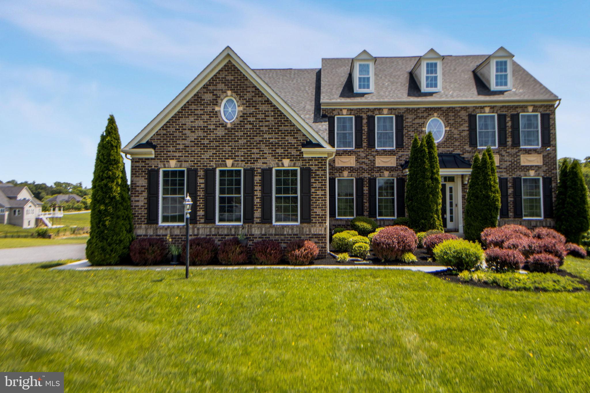 Premium 3-car, brick-front colonial in the sought after Warfields II subdivision is now available! Come see all of the many custom touches in this nearly 6,000 square foot exclusive residence. Enjoy a chef's kitchen with a sun drenched morning room, 2 smart wall ovens, propane gas cooktop, upgraded exhaust hood, granite countertops, breakfast bar & stainless steel appliances. Relax in the impressive 2-story family room with floor-to-ceiling stone fireplace, coffered ceilings & 7.2 surround sound system with receiver included. Take advantage of the main level home office with custom built in cabinets that are perfect for the space. Appreciate the functionality of the newly added (2022) lower level, 2 bedroom guest or in-law suite with its own kitchen, living room, full bath, washer, dryer & paver patio. Make use of the separate walk out level rear entry complete with an extra wide lighted walkway. Enjoy 4 large upper level bedrooms including a spacious owner's suite with bonus sitting area & covered balcony & soaking tub in the owner's full bath. Decide who gets the princess suite with its own private full bathroom. Value the Jack & Jill bedrooms with adjoining bathroom. Stay comfortable with 3 separate HVAC systems. Have enough power with two heavy-up electrical service panels and energy star appliances. Make good use of more than an acre of level land with sweeping views of farm conservation areas & southern exposure, great for a future pool! See the kids get on the bus from the window! Get in this home just in time to see the 4th of July fireworks from the driveway!