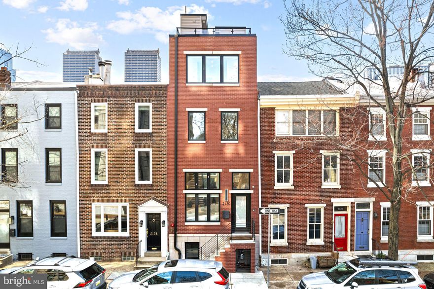 Welcome to 2130 Spring St, a one-of-a-kind home where every detail has been meticulously designed and crafted with the highest quality materials and construction. Nestled on a picturesque, tree-lined block just steps from Logan Square, this home seamlessly blends the tranquility of suburban living with the vibrancy and convenience of Philadelphia's finest offerings.

From the moment you step inside, you’re greeted by luxurious, large slab marble flooring that spans throughout the space, setting the tone for the home’s exceptional design. Soaring 18-foot tray ceilings elevate the living area, complemented by full-length windows that bathe the home in natural light. When night falls, the tray lighting and high-end sconces create a warm, inviting ambiance, perfect for relaxing or entertaining.

The open-concept kitchen and dining area are a chef’s dream, showcasing Brazilian Oak hardwood floors that beautifully complement the chic, custom Edel cabinetry, Moen faucets, and Mtech hardware. Top-tier GE, Wolf, and Dacor stainless steel appliances are built-in, including a hidden panel-ready dishwasher in the center island, ensuring both functionality and style. A sleek elevator provides access from the fully finished basement (complete with a full bath) to the stunning roof deck, adding both convenience and luxury to your daily living experience.

The second floor features two generously sized bedrooms, each with its own en-suite full bath. Large windows in every room flood the space with natural light, creating an airy and open feel. The conveniently located laundry room adds practicality to this level.

On the third story, you’ll find the show-stopping primary suite. The opulent marble primary bath features a resin stone soaking tub, a dual-head shower, and a private loo with smart technology—perfect for unwinding in style. Enjoy a peaceful, tree-top view as you soak away the day. A large walk-in closet adjoins the bath, and another walk-in closet is in the primary bedroom itself. Step out onto the Juliette balcony to take in breathtaking views of the city—whether sipping your morning coffee or savoring an evening Bordeaux.

The rooftop deck, accessible by either stairs or elevator, spans the entire length of the home and offers panoramic views of Center City and Logan Square. It’s the perfect spot for hosting dinner parties under the stars or watching the fireworks over the Parkway. With water and electrical hookups available, it also makes a fantastic space for your urban garden oasis.

This home is fully equipped with a six-zone sound system, controlled via iPad (with a dedicated control dock in the primary suite), as well as cameras, security features, and a smart thermostat. Want to make your home even smarter? 

Additionally, this exceptional property comes with a tax abatement for the first three years and seller is. Currently there is a parking permit from 5PM-8AM daily a rare find in this highly coveted neighborhood.

Don’t miss out on the opportunity to own this unparalleled home that offers the highest in quality, design, and customization—everything you’ve ever dreamed of in an urban sanctuary.