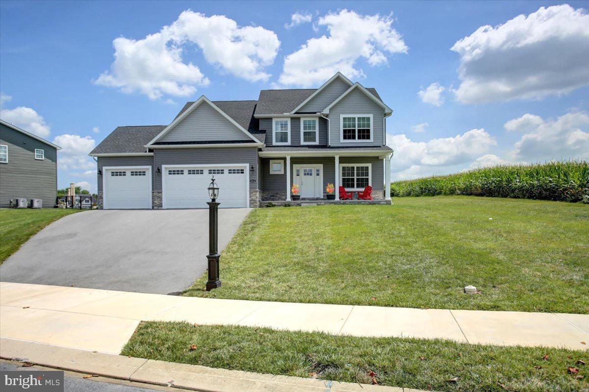 Welcome to 1014 Divinity Dr, a stunning 2022-built home nestled in the highly sought-after Heritage Estates neighborhood in Greencastle. This meticulously maintained property sits on a beautiful end lot, surrounded by serene cornfields, offering both privacy and breathtaking views. From the moment you step onto the covered front porch, you’ll feel the charm of this modern home, designed with top-end finishes throughout.
Inside, the spacious foyer entry leads to an open-concept main floor featuring a formal dining room, a gourmet kitchen with high-end finishes and a large island, a bright nook, and a welcoming living room—perfect for both everyday living and entertaining. Upstairs, the primary suite is a true sanctuary, complete with tray ceilings, a luxurious en-suite bathroom with a jetted tub, walk-in shower, and double vanities. The second floor also includes three additional well-sized bedrooms, a full bathroom and a laundry room.
The finished basement offers even more living space, including a bedroom, a full bathroom, a cozy living room, and an extra storage room. Outside, the Trex deck at the rear of the home provides the perfect spot for outdoor relaxation, overlooking the picturesque cornfields. With 5 spacious bedrooms, 4 bathrooms, and a 3-car garage, this home offers everything you need for modern living in a tranquil setting. Don’t miss your chance to call this beauty home—schedule a private tour today!