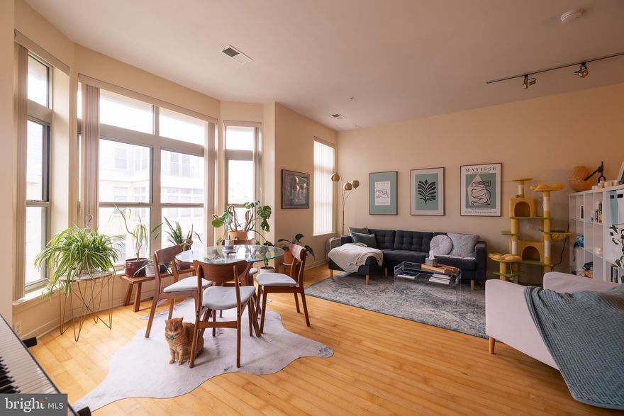 Now is your opportunity to own a luxurious condominium in the highly sought-after 1209 N Charles, ideally located in the heart of Midtown/Mount Vernon. Just steps from art houses, theaters, the Baltimore Symphony Orchestra, the University of Baltimore, and an array of restaurants offering international cuisine. Penn Station is only two blocks away, providing easy MARC and Amtrak access to Washington, DC, Boston, and beyond.

Designed for both relaxing and entertaining, this home features an exceptionally large living room—noticeably more spacious than most one-bedroom units in the building—offering rare flexibility for multiple seating areas, dining, or a work-from-home setup. Ten-foot ceilings and oversized bay and floor-to-ceiling windows fill the space with natural light, complemented by gleaming hardwood floors. Enjoy a private, courtyard-facing balcony that provides a peaceful retreat in the heart of the city.

The modern kitchen includes stainless steel appliances, gas cooking, and a breakfast bar, while the spacious bath offers a clean, contemporary design. A large private storage locker just steps from the unit and a dedicated garage parking space are included. Building amenities include a landscaped interior courtyard, on-site fitness center, and secure garage parking. Condo fees include both parking and storage.