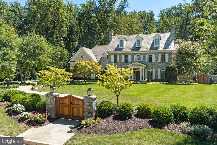 Welcome to Spring Hill Farm, an elite enclave in McLean, VA, where this stately home by George Sagatov embodies charm with superior, quality construction. A grand entrance with stone columns and custom paver drive welcomes you to this residence, featuring a distinguished exterior of stone and Hardiplank siding, a slate roof, and extensive front exterior landscaping & hardscaping by Surrounds Landscape Architecture & Construction. Home has been completely refreshed & remodeled over the last 5 years! 

Nestled on over an acre of lush, mature landscaping, this meticulously maintained property offers expansive views of the adjacent natural parkland. Inside, three levels of luxurious living space & a thoughtfully laid out floorplan, boast six fireplaces, elegant moldings, custom built-ins, and wide-plank wood floors. A wall of Palladian windows on the main level frames open views of the serene, private backyard - manicured & terraced with fresh sod & landscaping by McHale Landscape Design. The formal foyer, generous rooms, and flowing floor plan create an entertainer’s paradise, with a caterer’s kitchen designed for both grand events and intimate family gatherings.

The spacious, gourmet kitchen is a chef’s dream, with a large center island, custom cabinetry, Subzero refrigerator, Wolf six-burner range, double ovens, two dishwashers, and a HUGE walk-in pantry. You will love the deck off the kitchen with the addition of an elegant, heated, covered porch featuring two skylights, accent lighting and a gas fireplace with stone surround, seamlessly blending indoor and outdoor spaces for effortless entertaining and year-round comfort. A cherry-paneled office on the main level provides an inspiring workspace with views of the parkland beyond.

Upstairs, the owner’s suite is a luxurious retreat, complete with a gas fireplace and a spa-like bath featuring Phylrich faucets, heated limestone floors, an oversized two-person shower with Grohe fixtures, a whirlpool spa, and plenty of closet space. This level also includes three additional ensuite bedrooms, a laundry room off the primary suite, and large linen closets.

The lower level is designed for entertainment and relaxation, featuring a multi-level recreation room with a wet bar, double-sided stone fireplace, gym, wine cellar, an arts & crafts room, and a fifth ensuite bedroom. Watch movies & stream all your favorite sports in the media lounge, complete with a high-definition projector screen, offering a private cinema experience tailored for immersive entertainment.. A walk-out to the terraced garden leads to a stone patio with a fire pit, as well as a flat, grassy area ideal for a pool. The property backs directly onto Bull Neck Stream Valley Park, with gated access to a jogging trail that connects to the Spring Hill Recreation Center.

Just minutes from the Dulles Toll Road and Capital Beltway, this exquisite home offers both seclusion and easy access to Tysons, Washington, DC, and Bethesda. Discover your dream lifestyle at Spring Hill Farm, and a place where you will truly LOVE BEING HOME.