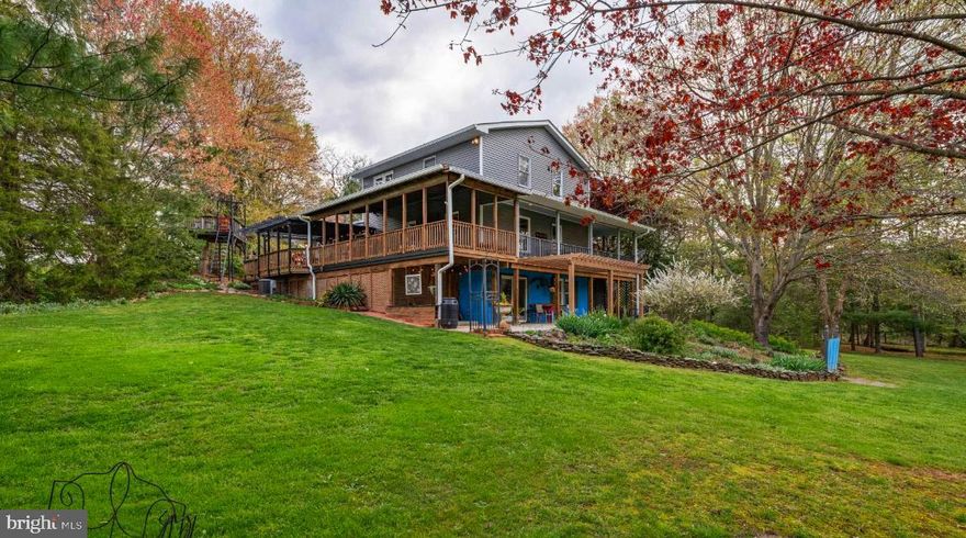 Nestled  on 2.73 acres with meandering stream, flowering trees and majestic gardens, this special home should be tops on your wish list!   Winding driveway leads to this three bedroom  2.5 bath, beautifully updated home with true wrap around porch, perola, huge covered deck, patio, eagles nest tree loft deck, barn/shed/workshop.    Wecoming front porch leads you into the main level featuring all hardwood floors throughout as well as crown moulding in the living and dining rooms.  Fantastic gourmet kitchen featuring upgraded stainless steel appliances, large kitchen island, and granite countertops with travertine backsplash.    Upstairs features all hardwood flooring and crown moulding,  primary bedroom with beautfully upgraded ensuite bathroom.  Two other generous sized bedrooms and wonderful upgraded hall bath round out the top floor.  The lower level features a light filled recreation  room, laundry room, storage room and adjacent craft room with walk out to lower porch which is one of the many special outdoor areas featured in this home.    Newer roof, siding, well pump .  This home has so much to offer, don't miss this amazing home!