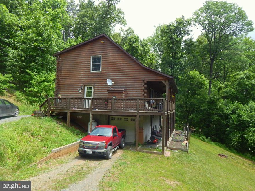 Gorgeous Log Cabin in Skyland Estates with privacy!  Just a few miles within of entrance to subdivision. 3-Levels with tons of living space throughout.