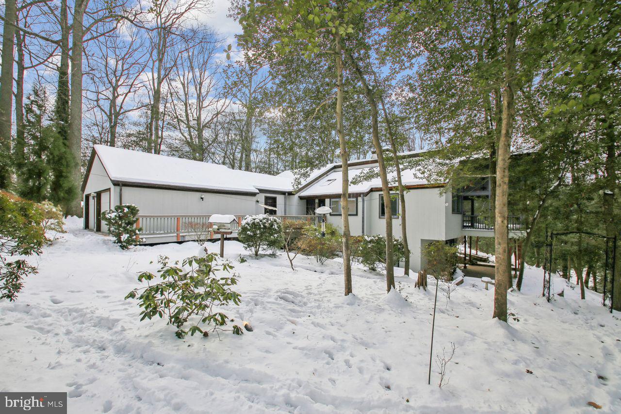 One of a kind in Fairwinds on the Severn. Custom built rancher in 1983 by a builder who specialized in renovating historical homes in Annapolis. This was the last home built in Fairwinds. He built this gem for himself on 1.2 acres tucked back off Windward Dr. This beautiful and private lot is just 2 blocks from the spectacular community beach with a marina, pool, clubhouse and playground! Vacation all year long right in your own community! Some of the fine features included in this home are cedar tongue and groove siding, long leaf yellow pine floors salvaged from warehouse beams from a Baltimore warehouse dating back to the civil war era. Many walls are reconditioned barn wood and many vaulted/cathedral ceilings are cedar planks. Other features include: HVAC replaced in 2024, Gutter Helmet, wood stove, alarm system, central vac, underground sprinkler, pond with waterfall and goldfish, Bose surround sound in great room, termite contract and extensive landscaping. The community is within walking distance to Blue Ribbon Benfield Elementary and Severna Park Middle Schools. Chartwell Golf and Country Club is within 2 miles. Also close to BWI Airport , Annapolis, Baltimore and DC. Vacation all year long in Fairwinds on the Severn!
