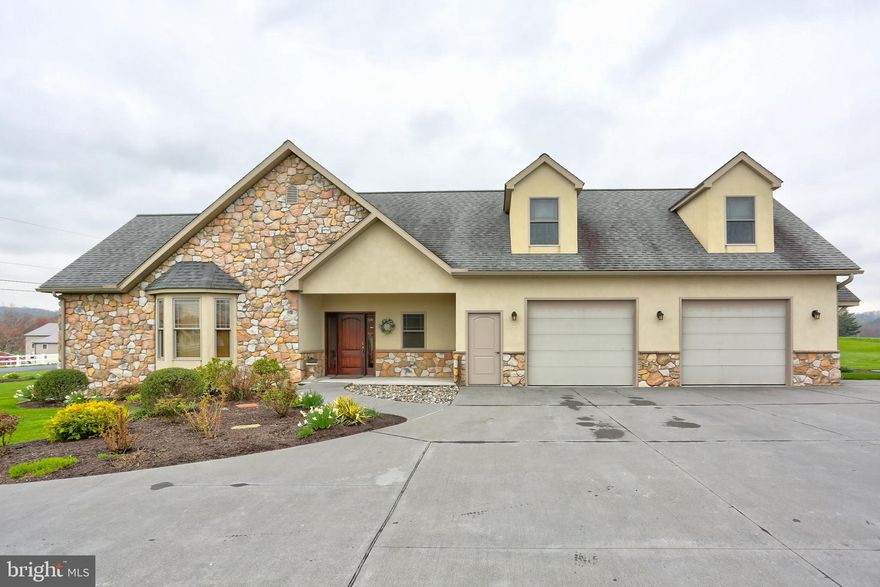 Beautiful custom built home in a quiet, private, country setting. First floor master suite is handicap accessible, with roll-in tile shower, has multiple closets, and recessed lighting. Custom kitchen contains double wall ovens, gas and electric range, butcher block island with built-in appliance storage, and butler pantry with a second refrigerator. Additional features include living room with stone surround fireplace, extensive finished basement with five rooms, elevator for easy transport between levels, hardwood floors throughout, and floor radiant heating. Attached 2-car garage is heated & cooled, and detached 4-car garage with heated workshop is perfect for additional storage space.