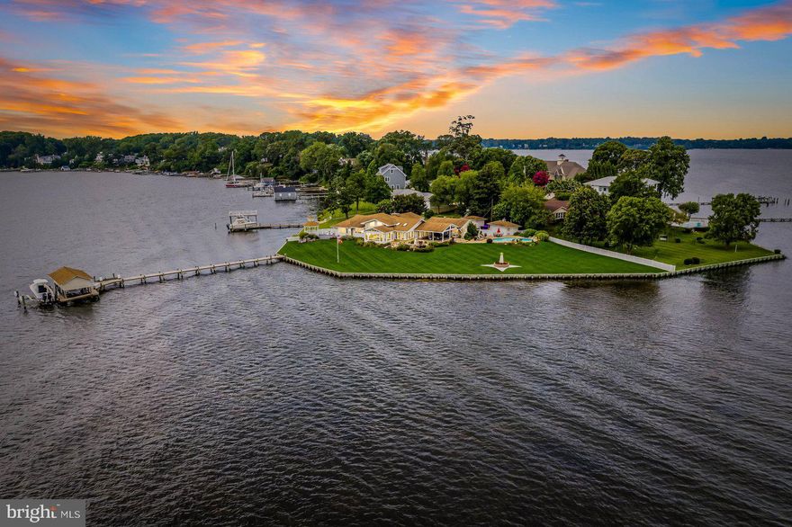 Maryland's local brokerage proudly presents... 201 Long Point Rd! Located on the tip of Long Point on the Severn, across from St. Helena Island, this waterfront estate has become a landmark on the Severn River and is an entertainer’s paradise! Situated on a sprawling 1+ acre flat lot with over 400 feet of direct water frontage, an in-ground pool, and 3 boat lifts; you will enjoy one floor living with gorgeous water views from every window! This stunning 6,278 sq. ft. home features 3 bedrooms and 3.5 baths in the main house, along with an additional 1 bedroom and 1 bath in the semi-attached guest/in-law quarters. With its range of desirable home features, this property is an entertainer's dream. Perfect home for water enthusiasts offering a private deep-water pier with 50 amps of power, along with a boat house and three boat lifts (20K, 10K, and 8K). And there's more - the owner has a permit for two additional pilings to create fourth boat slip/lift. Step inside the massive foyer with soaring 20-foot ceilings, custom built-ins, oversized coat closet, 2-story, double-sided stone gas fireplace, and be captivated by the seamless blend of sophistication and comfort. The Great Room offers unobstructed sight lines to the water, while the light-filled, four-
season sunroom features panoramic views of the Severn River. The lovely eat-in kitchen, complete with stainless steel appliances, granite countertops, coffee bar, 2 large pantries, and a center island, is perfect for entertaining. Large dining room w/skylights off the kitchen spills over into the Great Room for a true open-concept design maximizing the scenic vistas of the Severn River from every room in the house. The
Primary suite is a true haven of relaxation, with a private deck and gazebo, tray ceilings,
window seat, sweeping views of the water, multiple closets, dressing area, and ensuite bathroom. Enjoy two guest bedrooms: one a private suite w/ensuite bathroom. Partially finished basement provides additional living space. On this level is a large laundry room w/ plenty of storage, cedar closet, space for a home gym, workshop and safe room! Off the Kitchen, you will find an expansive covered lanai inviting you to indulge in outdoor living at its best. The huge private back yard with in-ground pool, decorative pond feature, lighthouses and extensive hardscaping/landscaping provides a great place to host lavish parties, a recent family wedding, or simply lounging with loved ones and friends against the picturesque backdrop of the Severn River. Enjoy front row seats for the Sherwood Forest July 3rd spectacular fireworks show. The saltwater, heated pool offers a refreshing oasis on warm summer days, while the oversized 2-car garage with RaceTrack flooring provides ample space for vehicles and storage. This property accommodates parking for 8-10 cars, a rare find in this community. This home has had many major renovations since it’s purchase; increasing bedrooms, dramatically raising ceiling heights, as well as finished square footage. All rooms in the home have ceiling heights ranging from 10 – 20ft. (vaulted/tray). Enjoy endless waterfront activities like boating, fishing, paddleboarding (2 convey), and kayaking. You are perfectly positioned to take advantage of Chesapeake Bay's best cruising and fishing areas, with the option to boat to Annapolis for shopping or dinner. Located on a quiet cul-de-sac in the coveted Long Point on the Severn community, this home provides the perfect balance of seclusion and accessibility. Convenient access to General's Highway, provides quick connections to Annapolis, BWI, Baltimore, DC, and Route 97. Iconic waterfront paradises on the Severn, with too many features to list, rarely become available, so don't miss this opportunity. Schedule your private tour today!