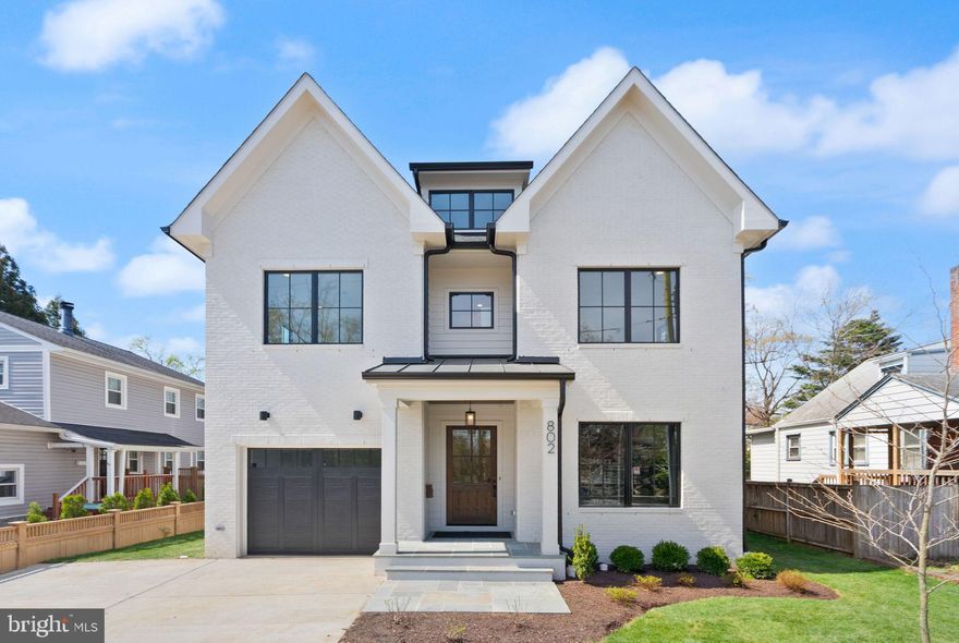 Welcome to this stunning contemporary new construction home — a perfect blend of modern elegance, thoughtful design, and everyday comfort. With nearly 4,500 finished square feet on a level lot, this exceptional residence offers 5 bedrooms and 5.5 bathrooms across four beautifully finished levels with GARAGE and 3 COVERED OUTDOOR LIVING SPACES.   The heart of the home is the showcase gourmet kitchen, featuring custom cabinetry, high-end Wolf and Sub-Zero appliances, and a large quartzite island that opens seamlessly to the family room and informal dining area. Sliding French doors lead to a spacious screened porch, creating an effortless indoor-outdoor flow that’s perfect for entertaining or relaxing. A stylish home office, a mudroom with built-in bench and cubbies, and a convenient powder room complete the main level. Upstairs, the serene primary suite is a true retreat with a private covered deck and a spa-inspired bath featuring a double vanity, a frameless glass shower, a freestanding soaking tub, heated floors, and an oversized walk-in closet with custom shelving. Two additional bedrooms with en-suite baths and a spacious laundry room complete the second floor. The third level offers a versatile loft with a wet bar and access to a  with  COVERED ROOF TOP DECK— the perfect spot to unwind and watch the sunset. A private guest suite with a full bath makes this level ideal for visitors. The lower level provides even more space to live and play, including a large recreation room with a wet bar, exercise room, bedroom, and full bath. Additional highlights include 10-foot ceilings on the main level, white oak flooring throughout, ceiling-mounted speakers in key rooms, Wi-Fi programmable thermostats, one-car garage wired for an EV charger with 2 OFF STREET parking spaces and abundant storage. Enjoy year-round comfort on the three-season screened porch with ceiling heaters and fan, overlooking the backyard — a perfect space for gatherings with family and friends. Every detail has been carefully considered to create a home that is as functional as it is beautiful — one you’ll love coming home to every day. Perfectly positioned near the heart of Clarendon and less than a block from Washington Boulevard, this location offers the best of urban convenience and neighborhood charm. Enjoy effortless access to Ballston Quarter, Clarendon, Fort Myer, and the Virginia Square Metro. With Amazon HQ2, the Pentagon, Pentagon City Mall, and the Army-Navy Country Club less than ten minutes away, you’re connected to the area’s top destinations in moments. And with just two Metro stops to downtown D.C., this address combines vibrant city living with the comfort of a close-knit community. Only 2 Metro stops to DC. Within .5 mile of LONG BRANCH ES and THOMAS JEFFERSON MS. WASHINGTON-LIBERTY HS.